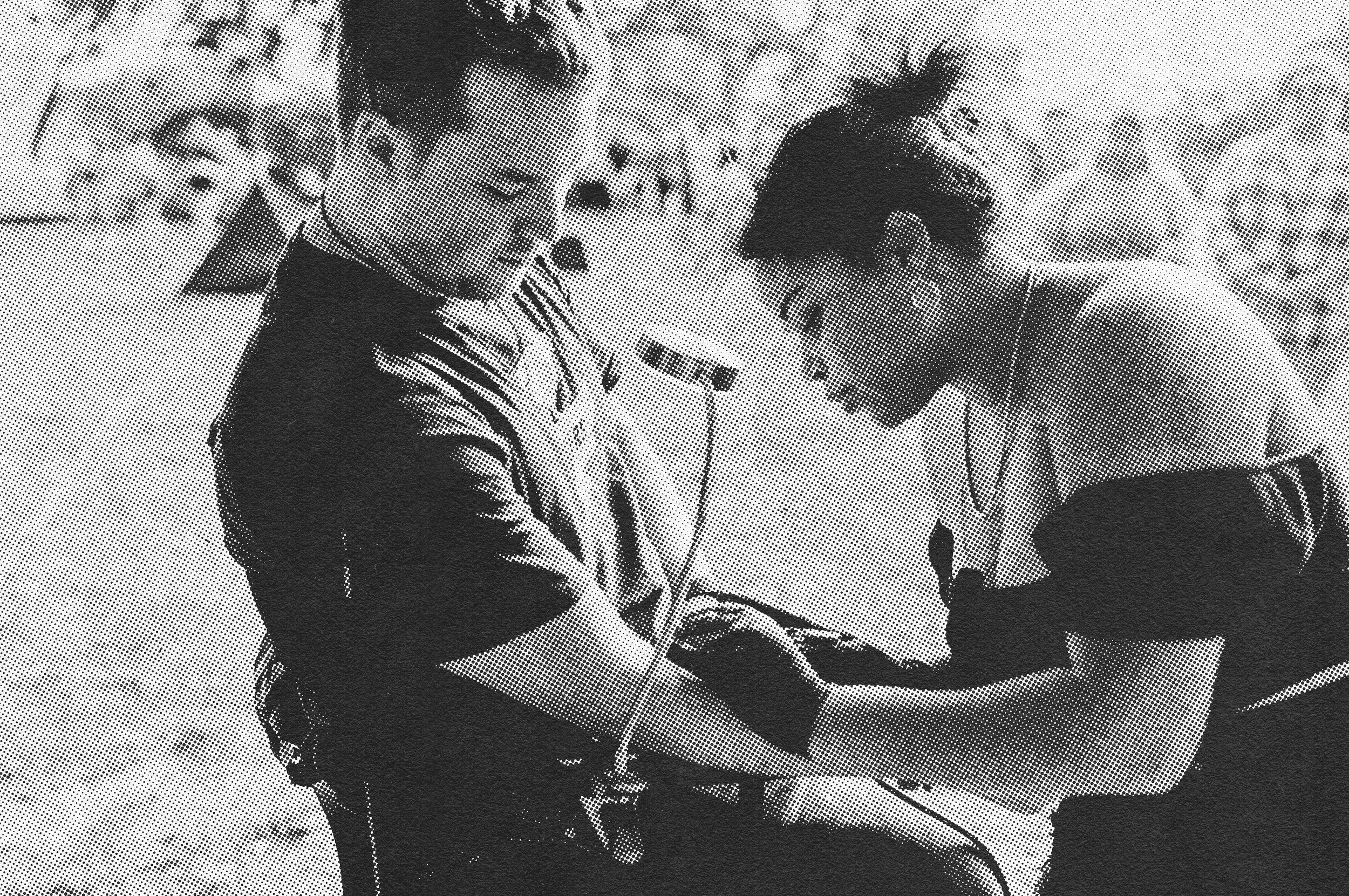 Black and white photo of an artist doing a temporary airbrush tattoo