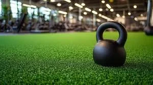 Kettlebell on artificial turf in a gym.