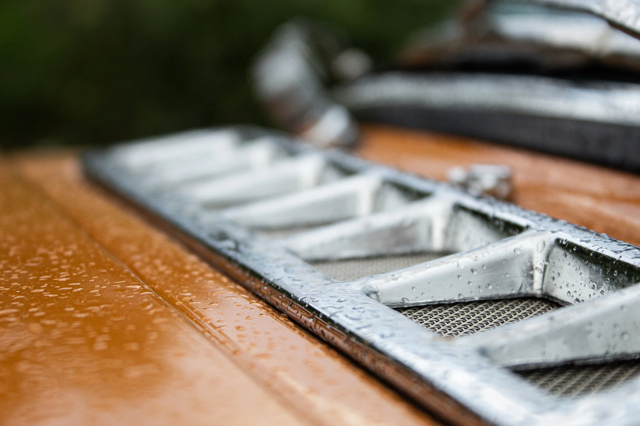 Close-up of a wet electric stove with water droplets on the surface and metal heating elements.