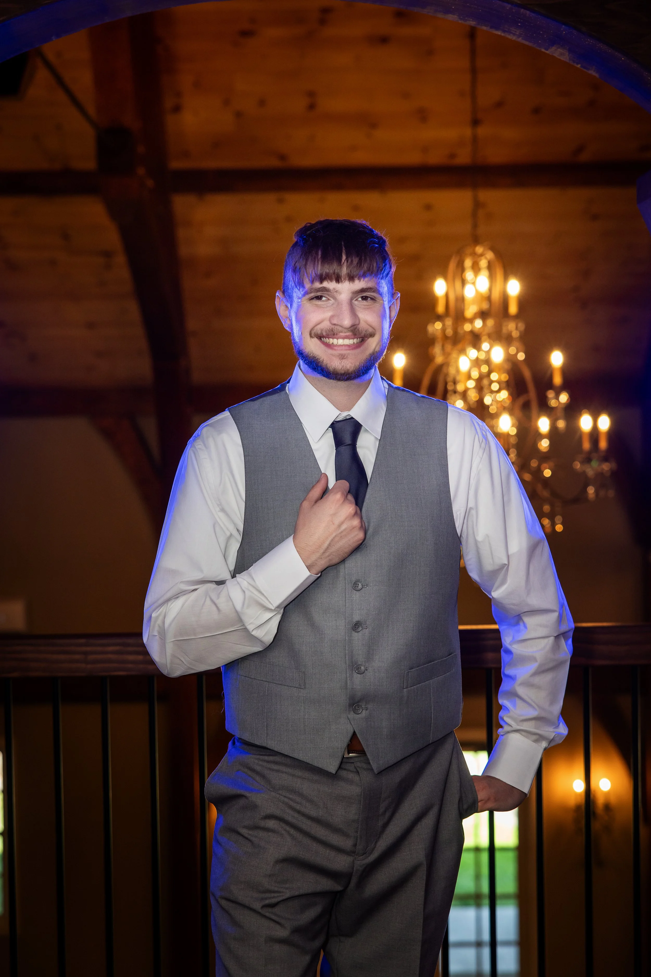Chandelier behind the groom at The English Barn