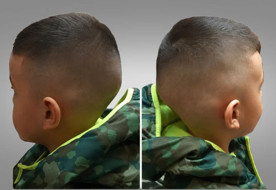A side-by-side comparison of a young boy's head from two angles, showing a short, faded haircut with a low fade on the sides and slightly longer hair on top, wearing a camouflage jacket with lime green accents.