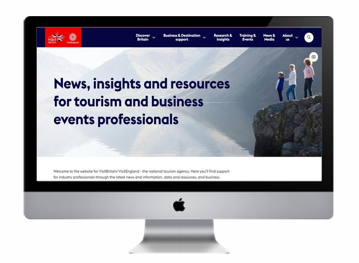 Screenshot of a website homepage for VisitBritain, displaying a header with menus and a main section with the text "News, insights and resources for tourism and business events professionals" over a scenic mountain and lake background with three people standing on a rock ledge.