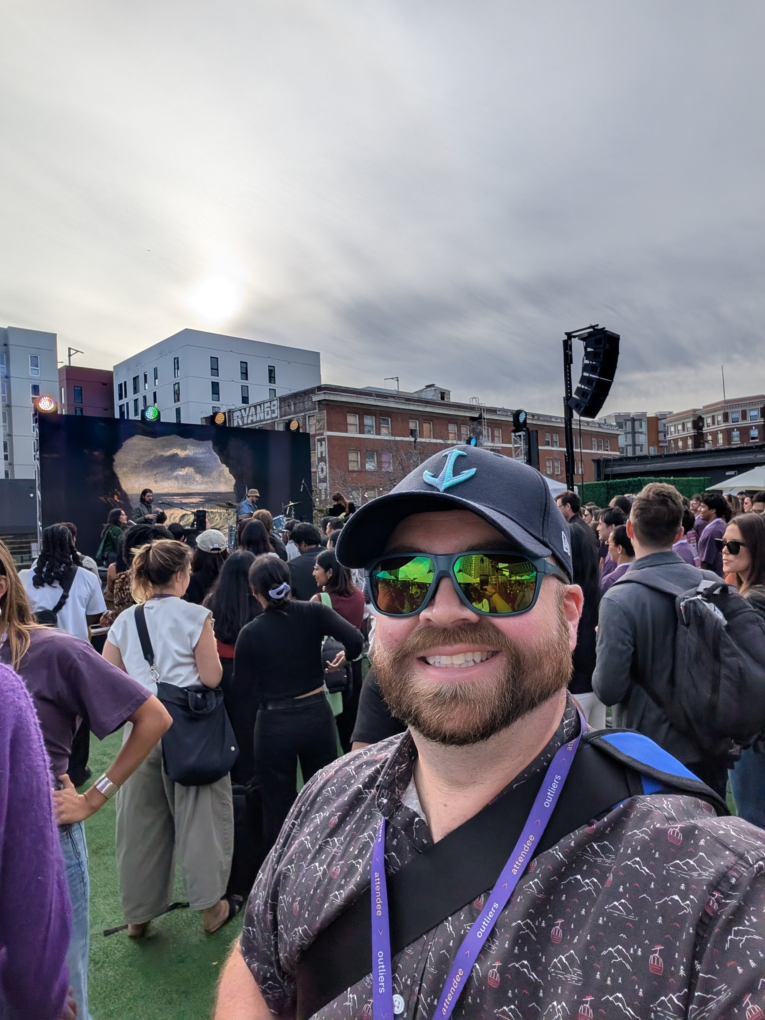 The author, Ross Lordon, standing in a crowd in front of the outdoor stage with Vanessa Carlton and her band performing in the background.