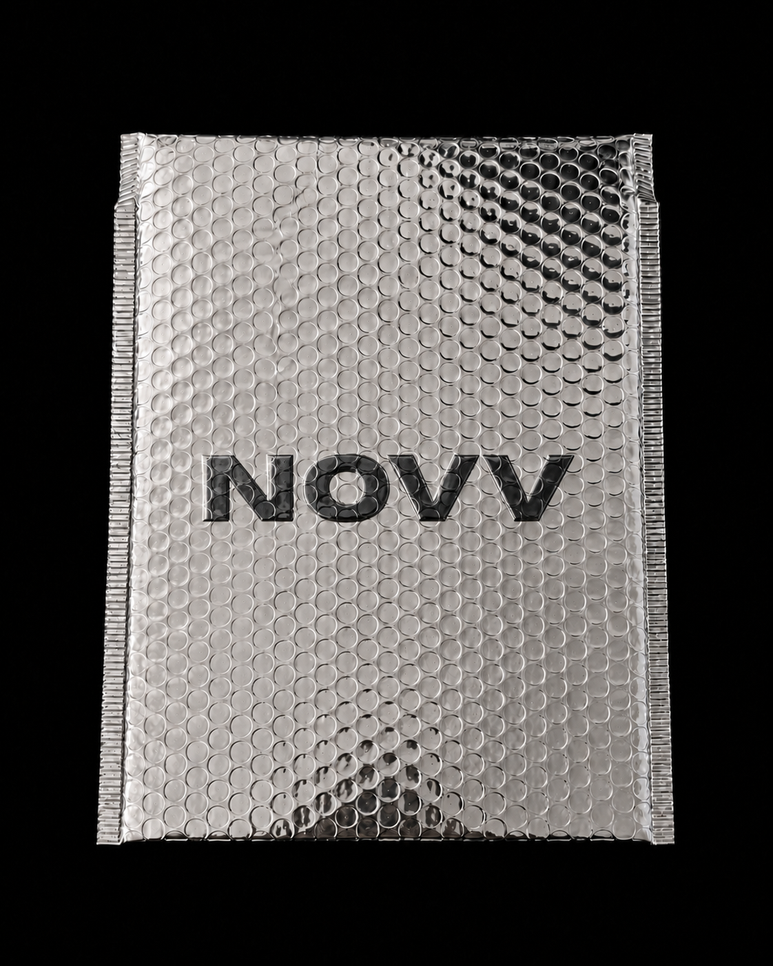 Silver bubble wrap envelope with the word 'NOVV' on it, against a black background.