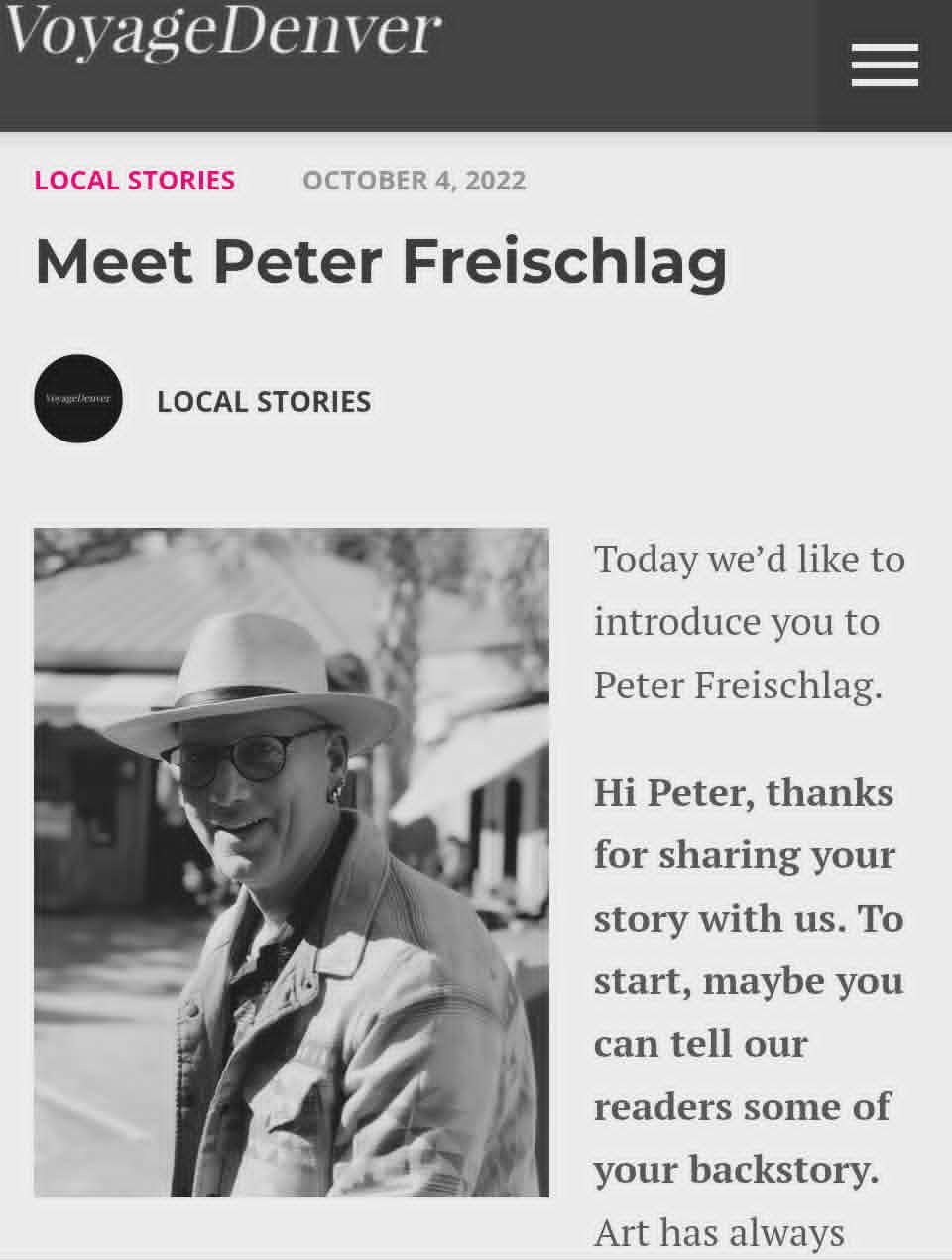 A grayscale portrait of Peter Freischlag, wearing a hat, glasses, and a jacket, smiling outdoors with trees and buildings in the background.