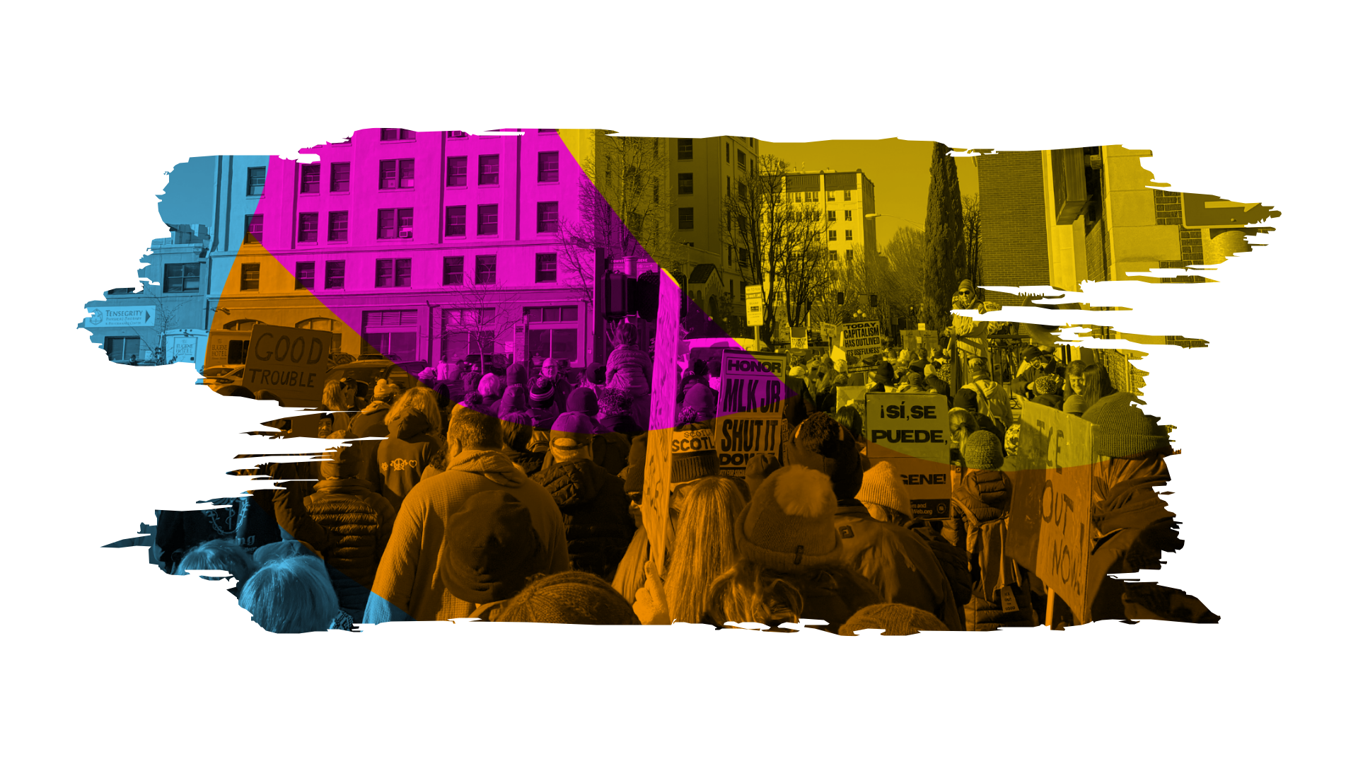 A large crowd of people gathered in rally or protest wtih NAACP Eugene-Springfield, Oregon holding various signs on a city street, with buildings and trees in the background.