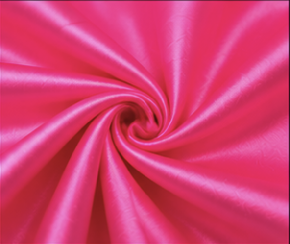 Close-up of pink satin fabric twisted in a spiral.