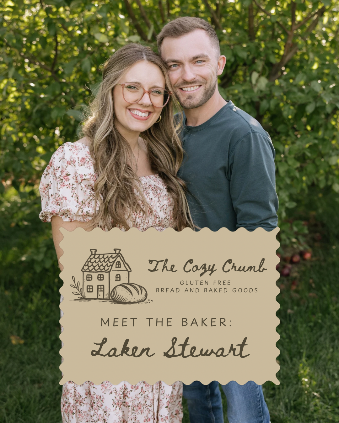 A smiling young woman and man standing outdoors in front of green foliage, holding a sign for a gluten-free bakery named The Cozy Crumb. The sign features a house, a pumpkin, and text introducing the baker, Laken Stewart.