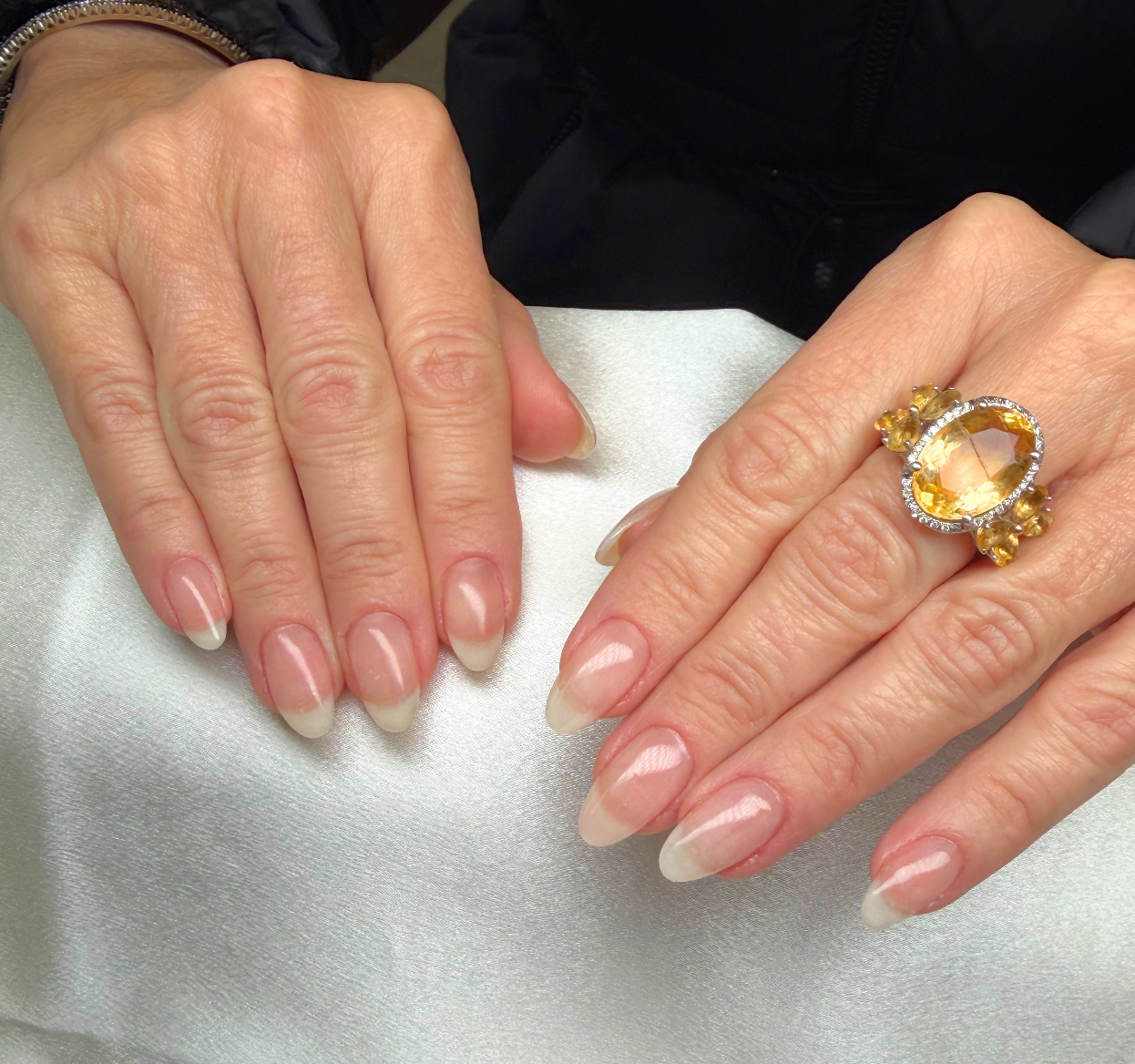 Close-up of nails manicured with a French tip style.