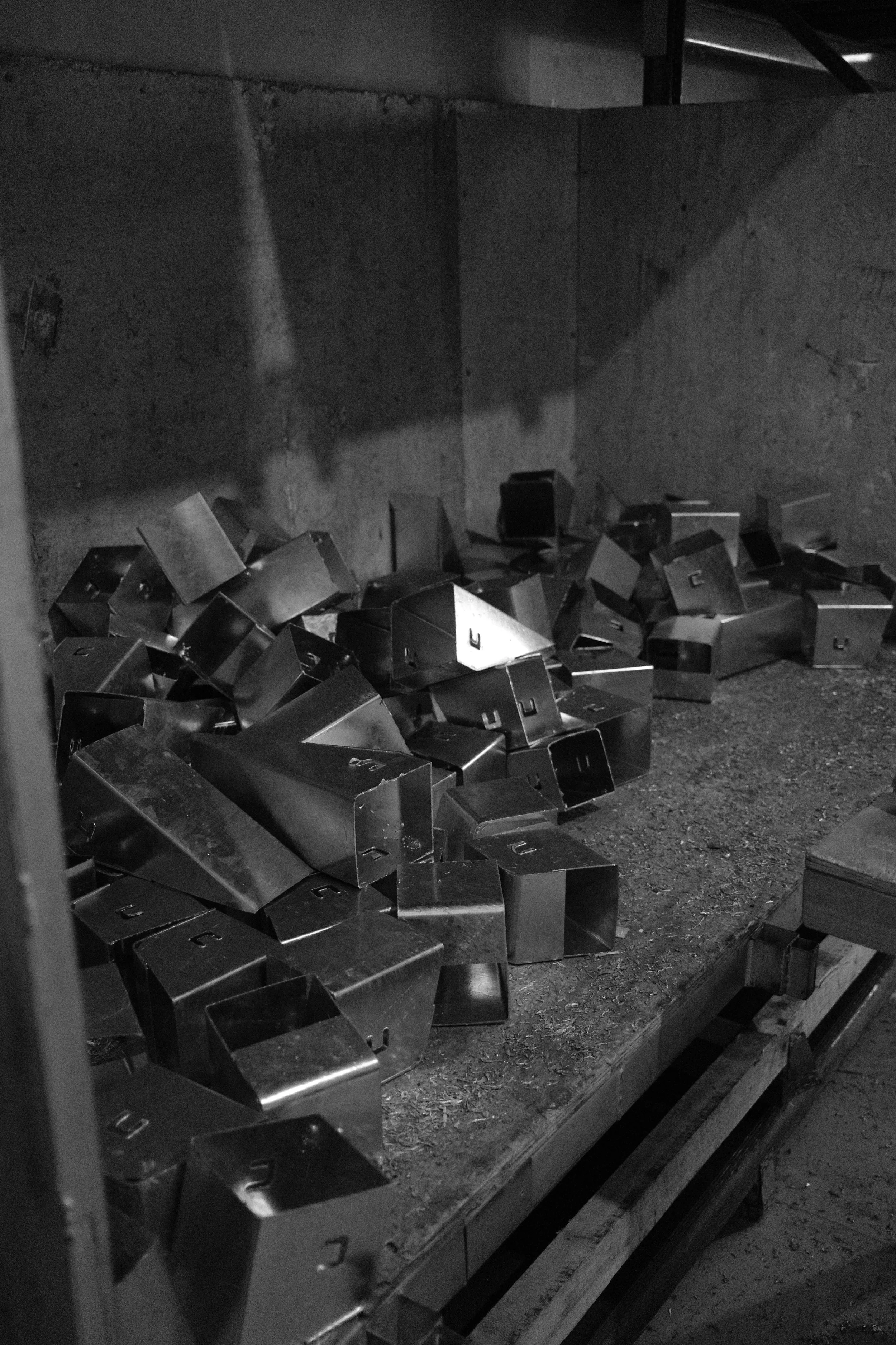 A wooden container with AdaptaKerbs scattered inside about to be boxed ready for orders.