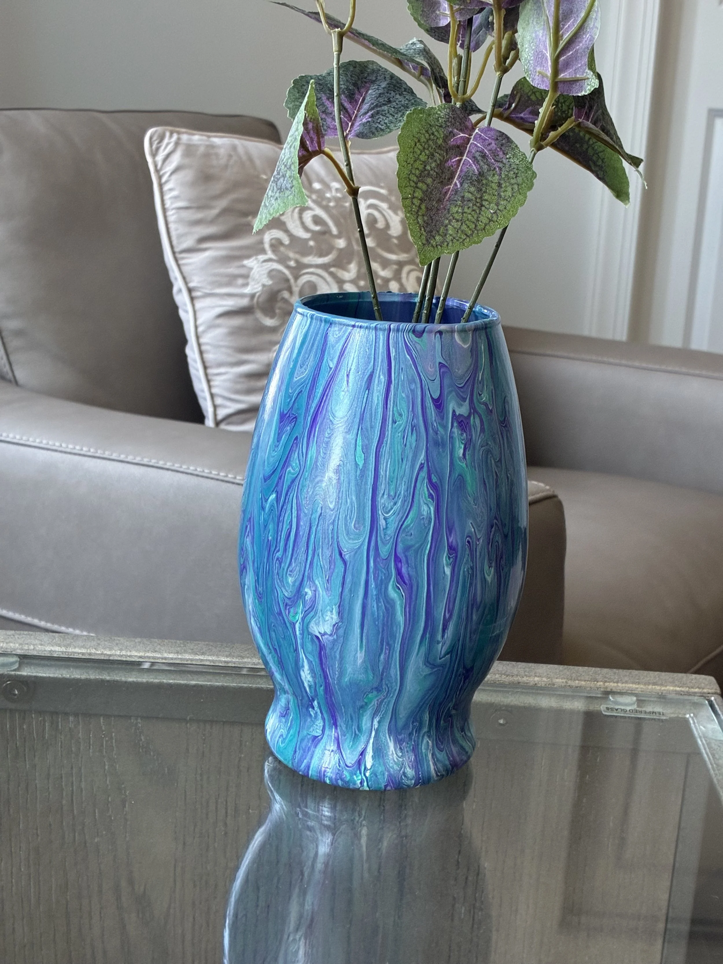 Amethyst Tide captures the beauty of rolling ocean currents through layered blues and amethyst tones. Its fluid movement and glossy finish create a striking statement piece that brings color, depth, and elegance to any space.