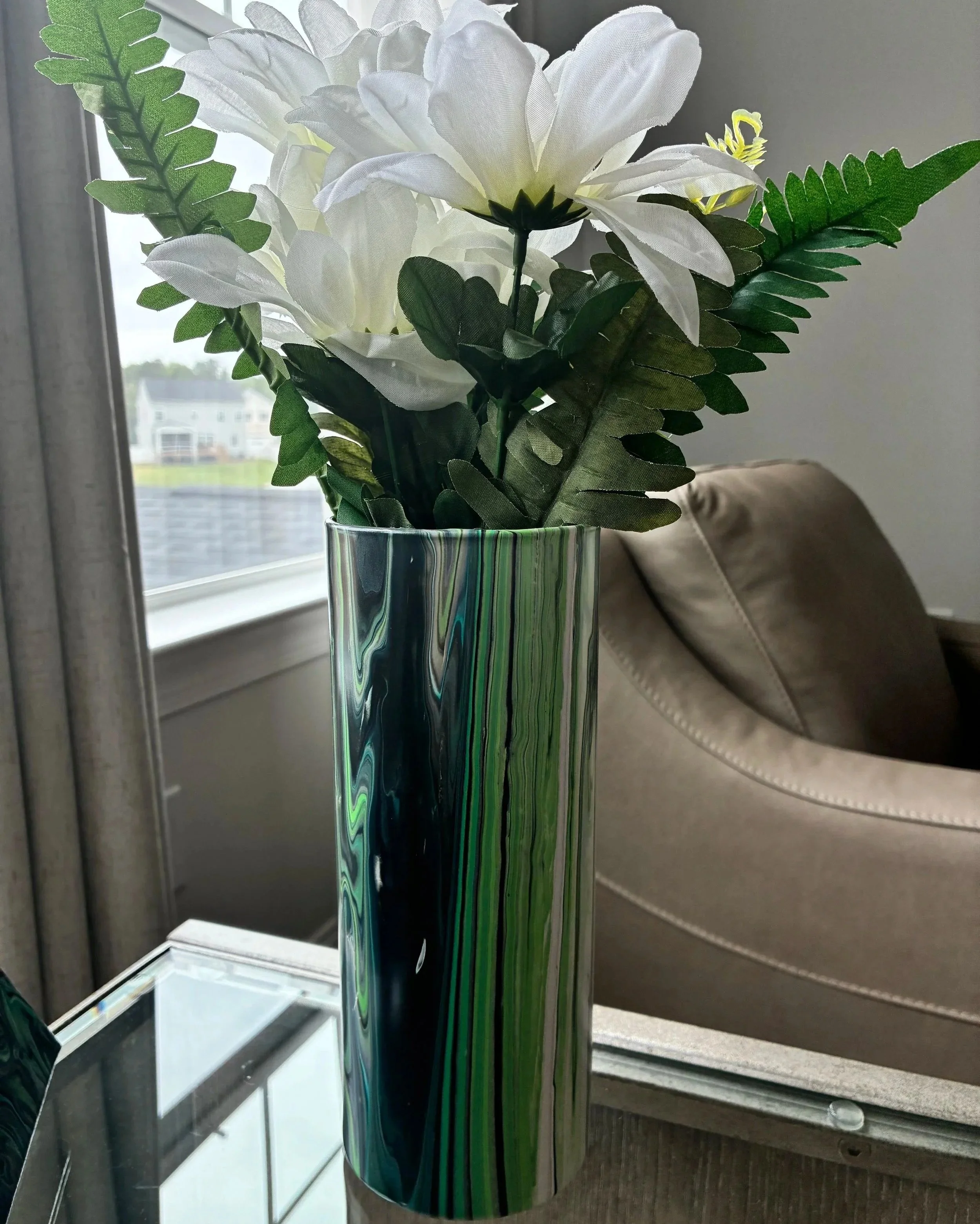 Decorative acrylic pour vase featuring soft emerald movement and fluid stone-inspired lines.