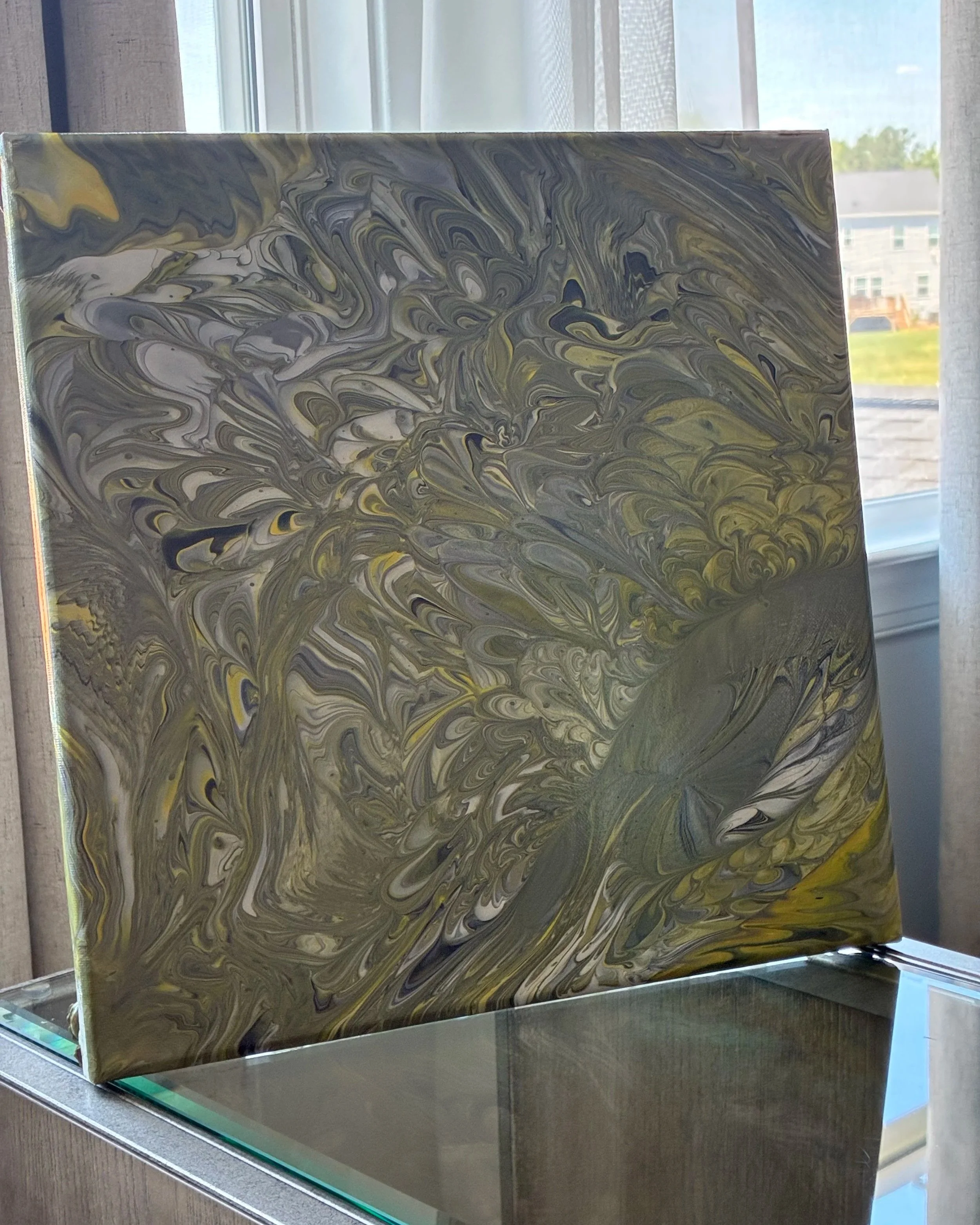 Swirling currents of moss green, charcoal, and muted metallic tones create a landscape of movement and depth, capturing the raw energy and quiet mystery of the natural world.
