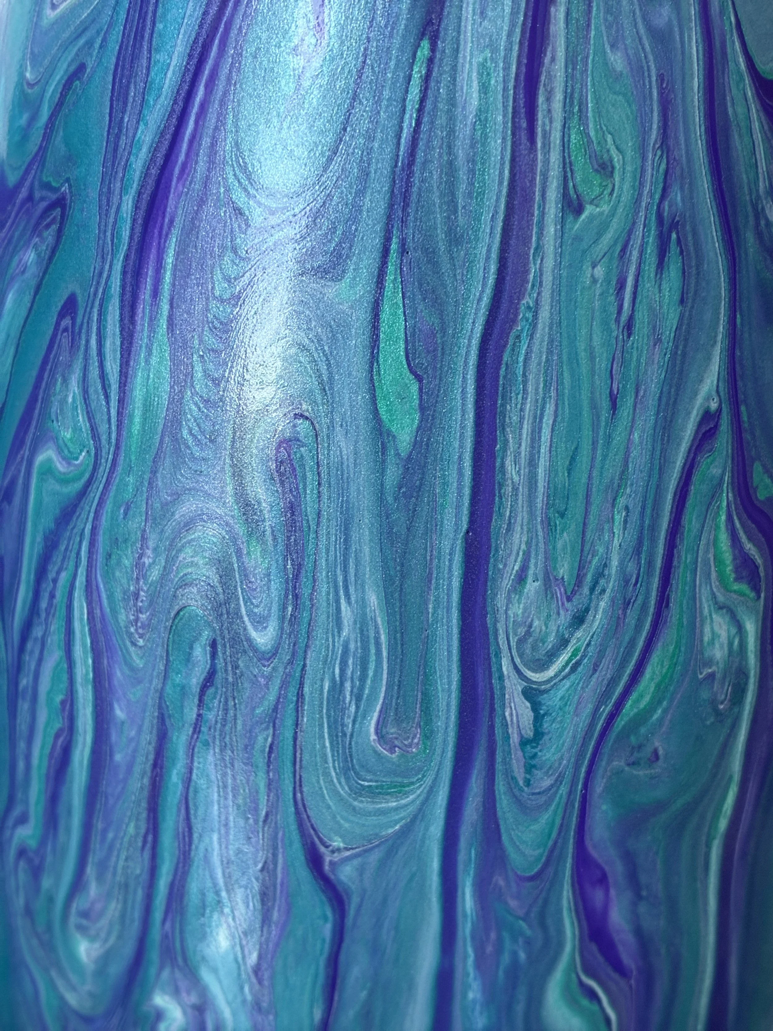 An intimate detail of Amethyst Tide highlighting luminous blue and violet tones, layered textures, and fluid lines reminiscent of ocean currents and polished sea glass.