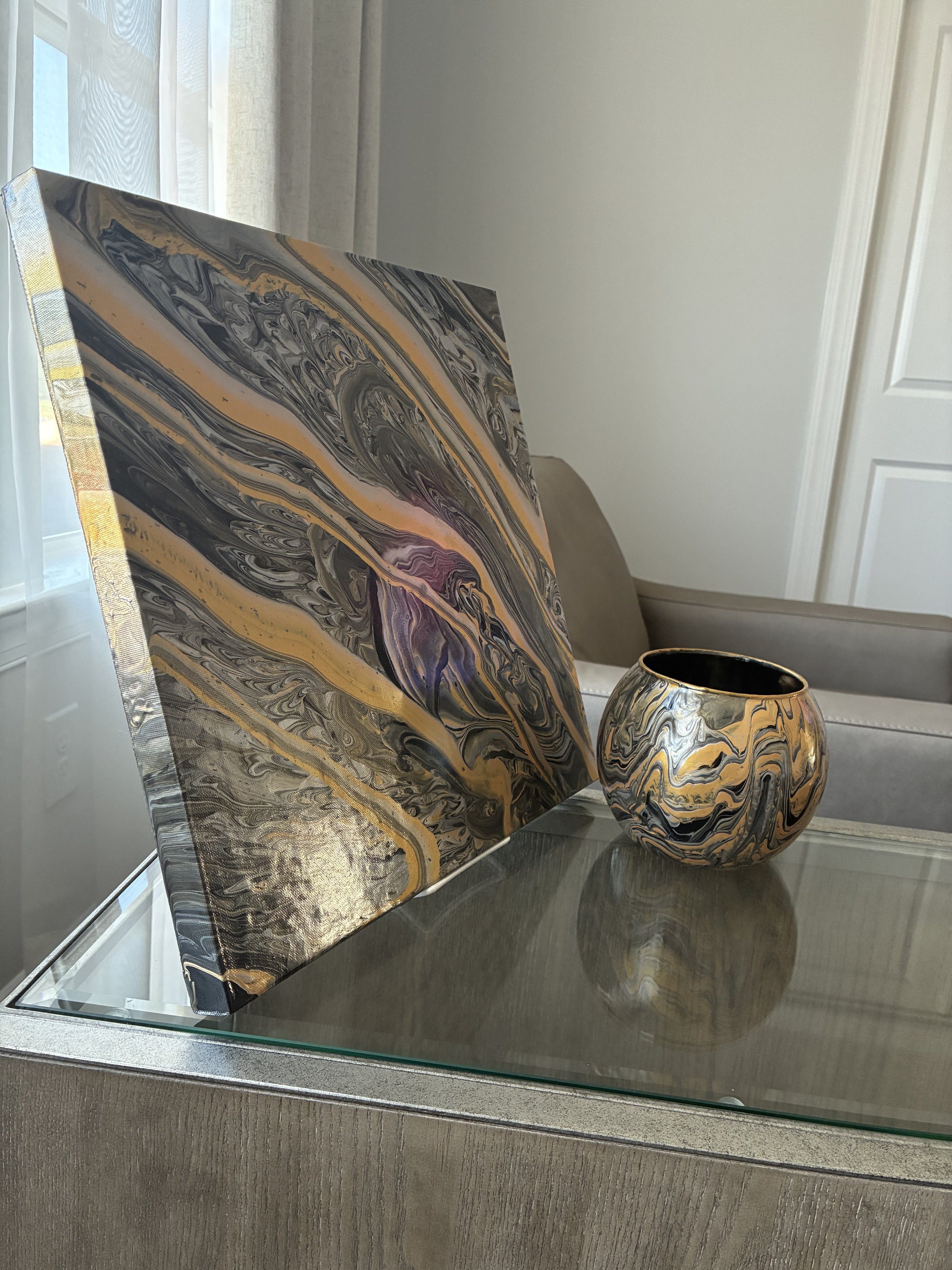 An elegant pairing of flowing metallic gold, charcoal, and black inspired by natural stone, movement, and modern luxury.