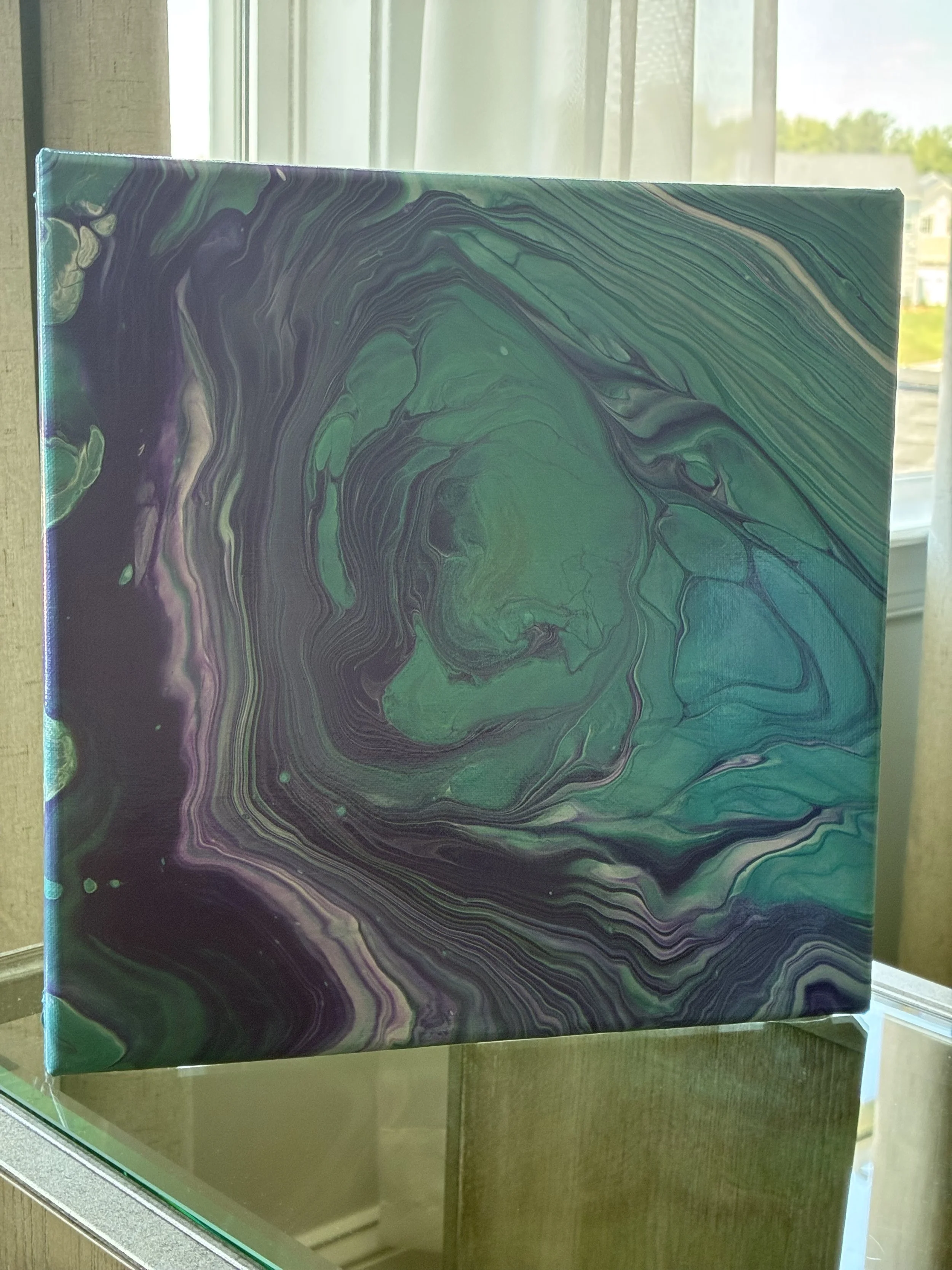 Sea Glass Veil captures the fluid beauty of ocean-worn glass in motion. Layers of teal, amethyst, and violet flow together to create a calming yet dramatic statement piece filled with depth and movement.