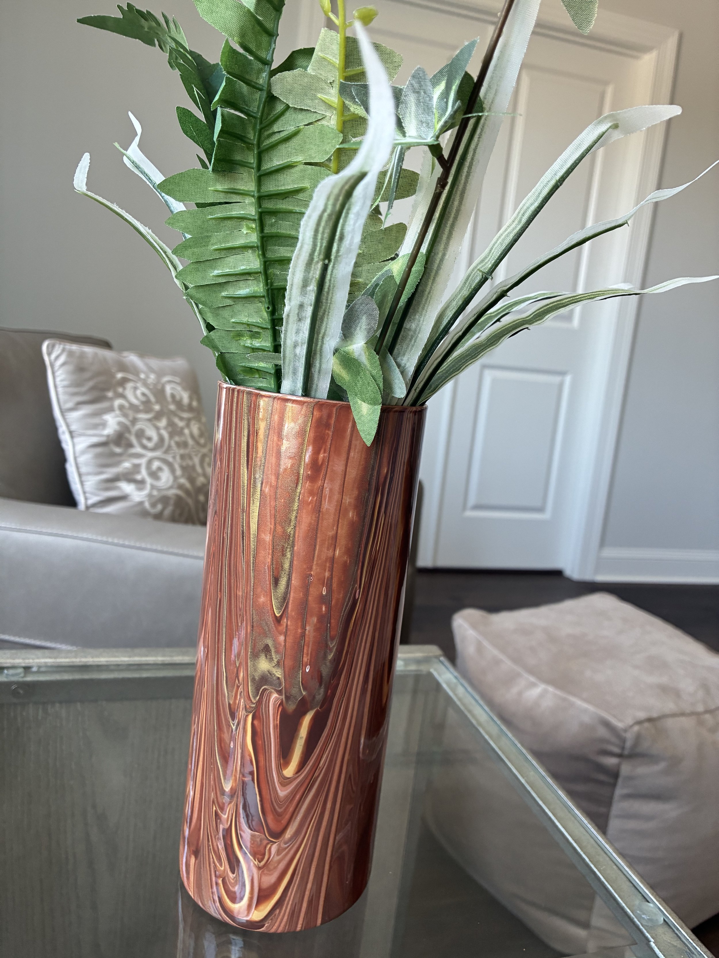 Warm bronze, copper, and stone-inspired currents flow across the vessel, creating an elegant expression of earth's natural textures and timeless beauty.