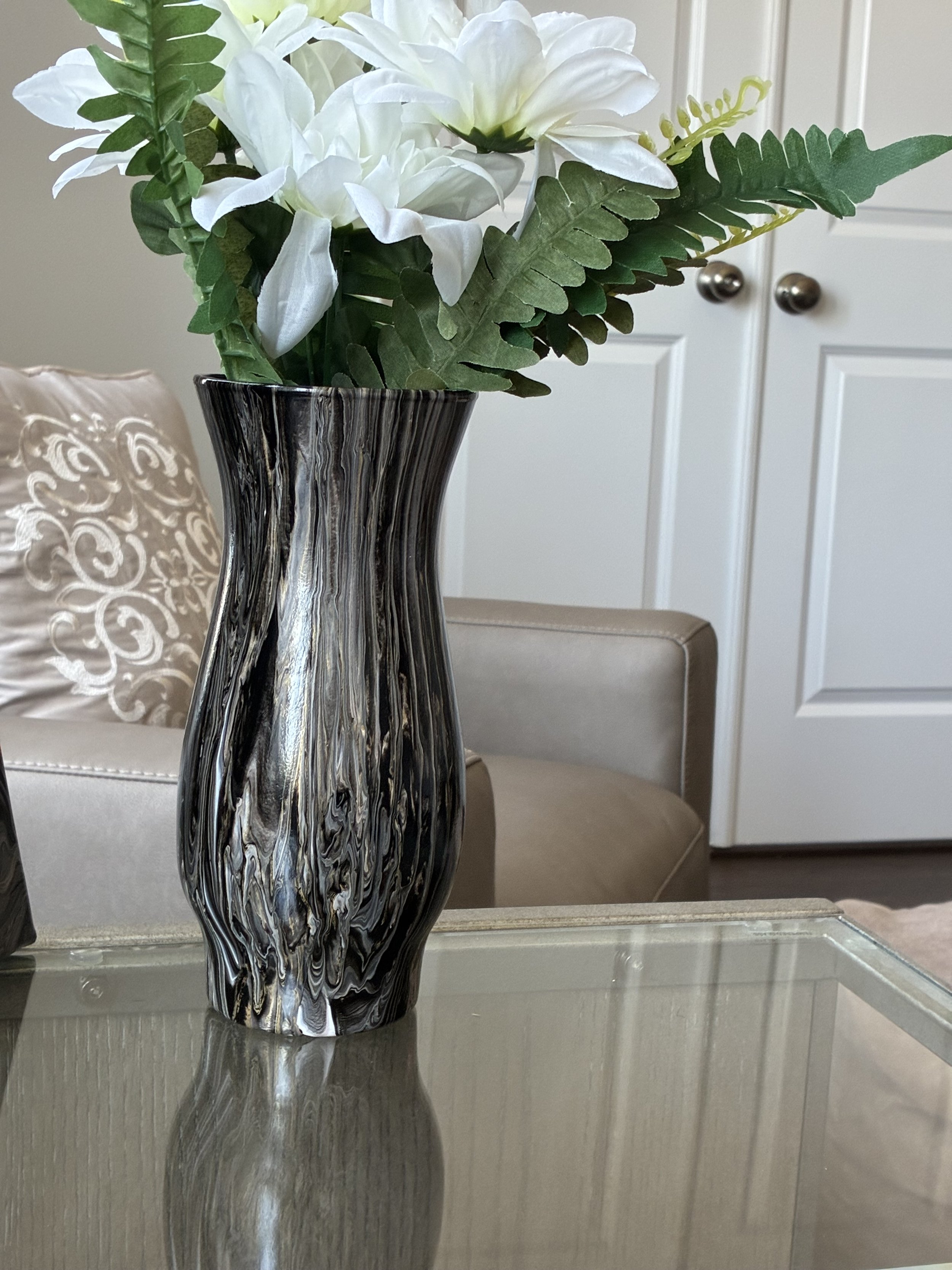 Flowing layers of black, charcoal, silver, and bronze create a striking vessel inspired by the depth and elegance of natural onyx. Designed to complement Blackwater Vein within the Obsidian Vein Collection.