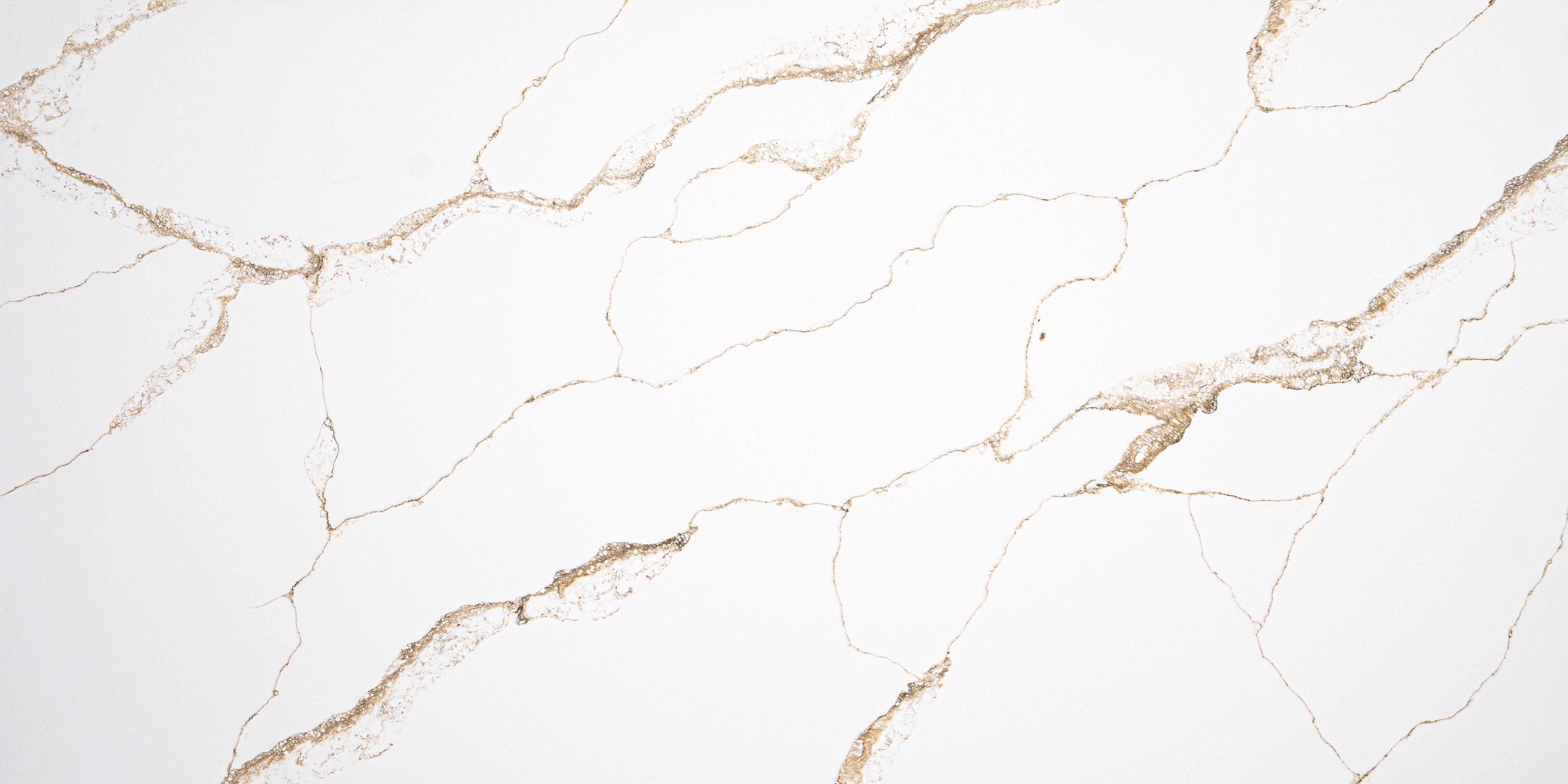 White marble surface with gold and light brown veining.