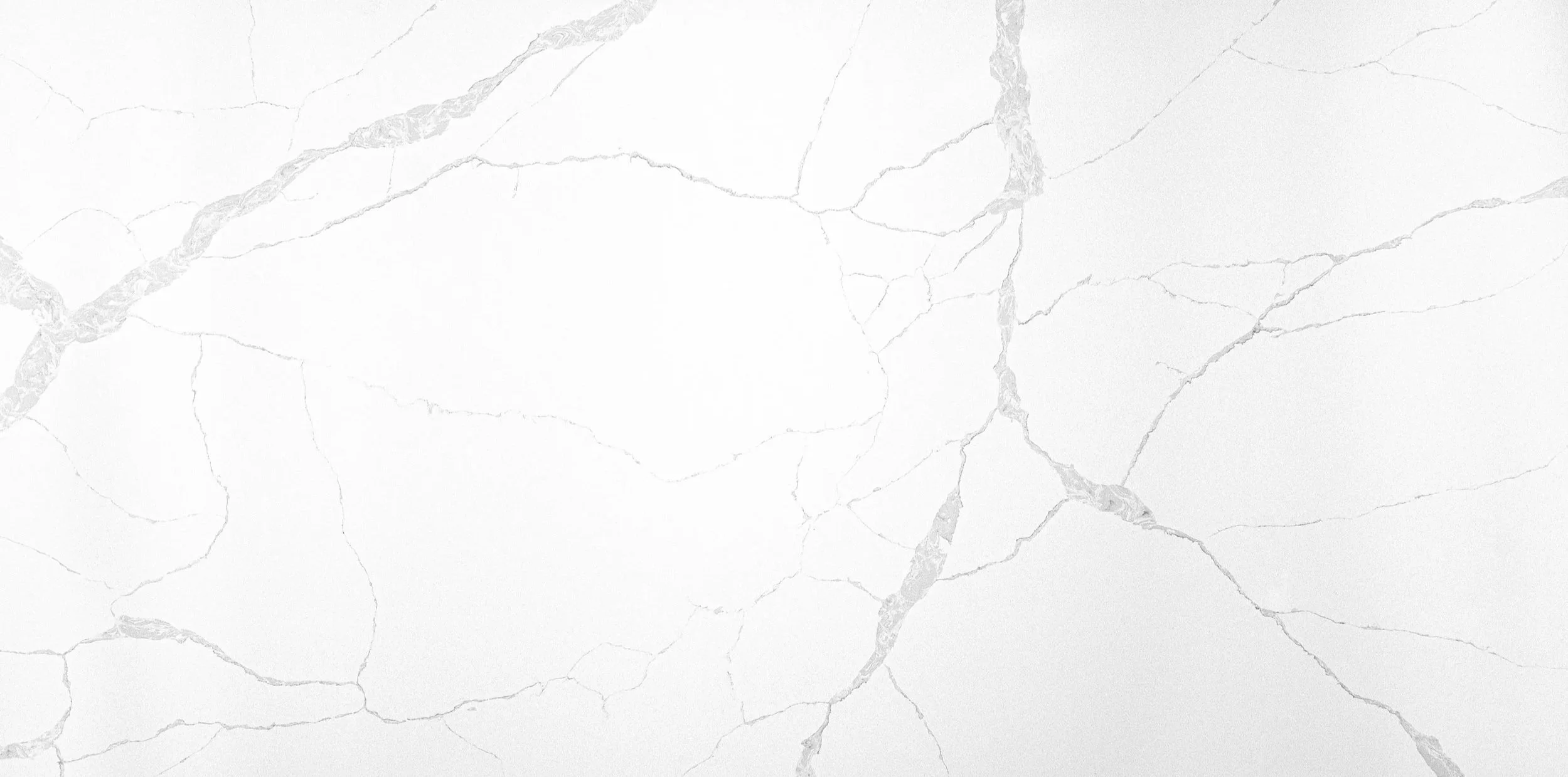 White marble surface with gray veins and cracks.