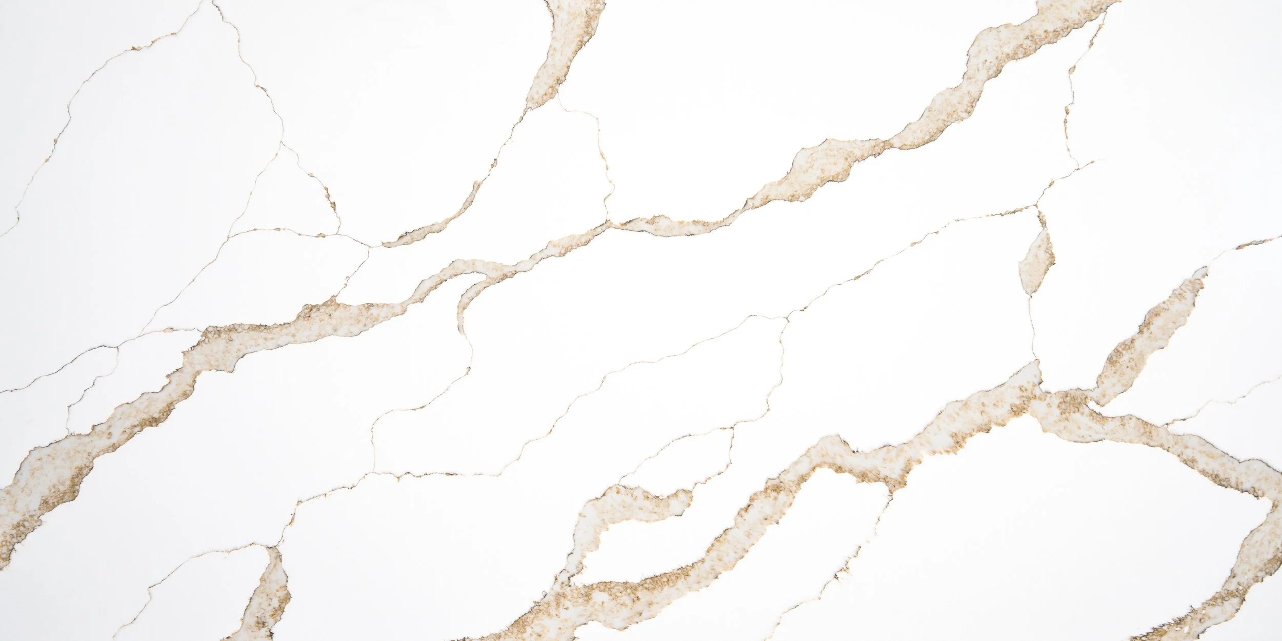 White marble surface with beige and brown veining.