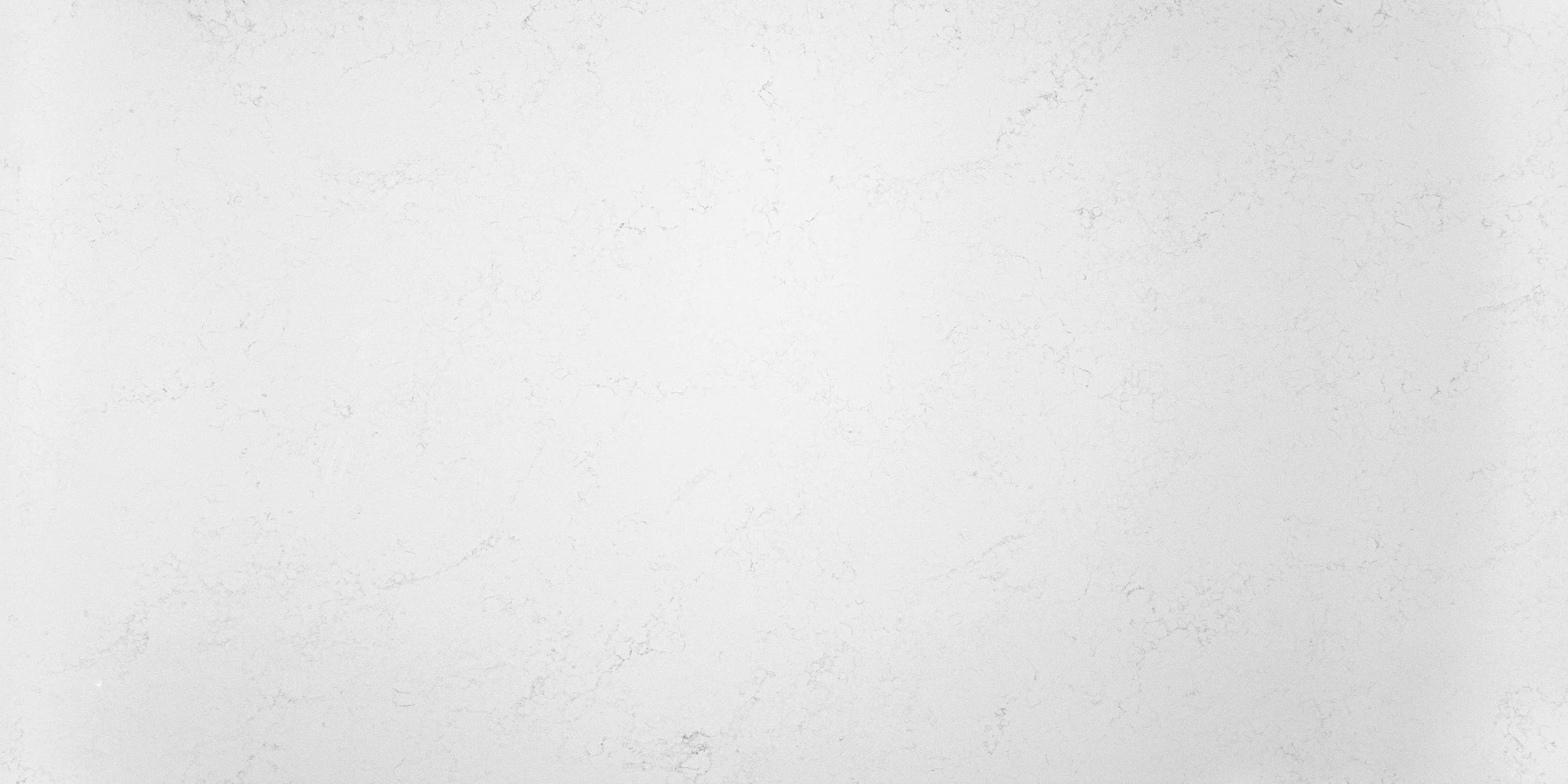 Empty white marble surface with subtle veining and texture.