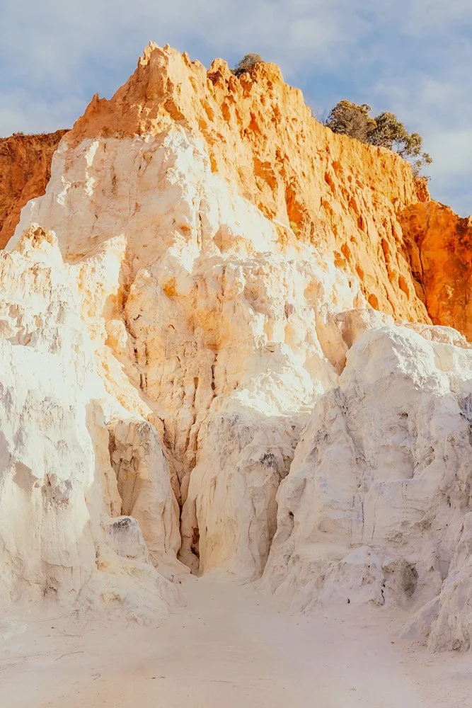 rocky hill showing contrasting rock types in orange and white colours