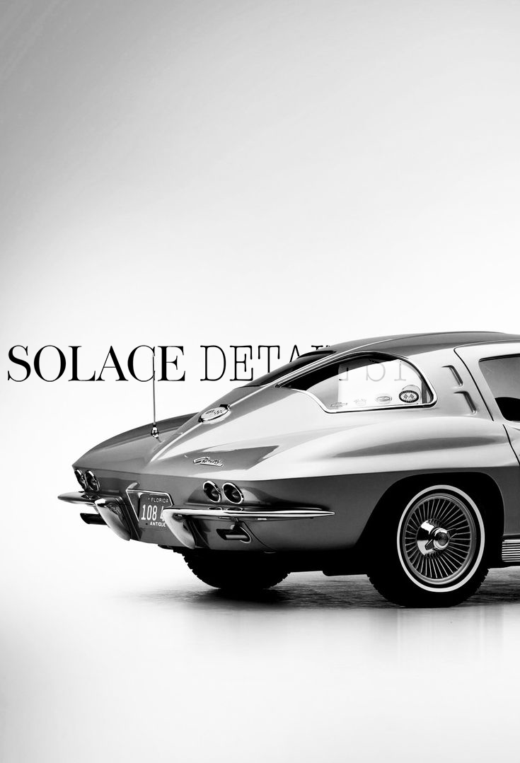 A black and white photo of a classic vintage car, showing the rear and side views, with text 'Solace Detail' in the background.