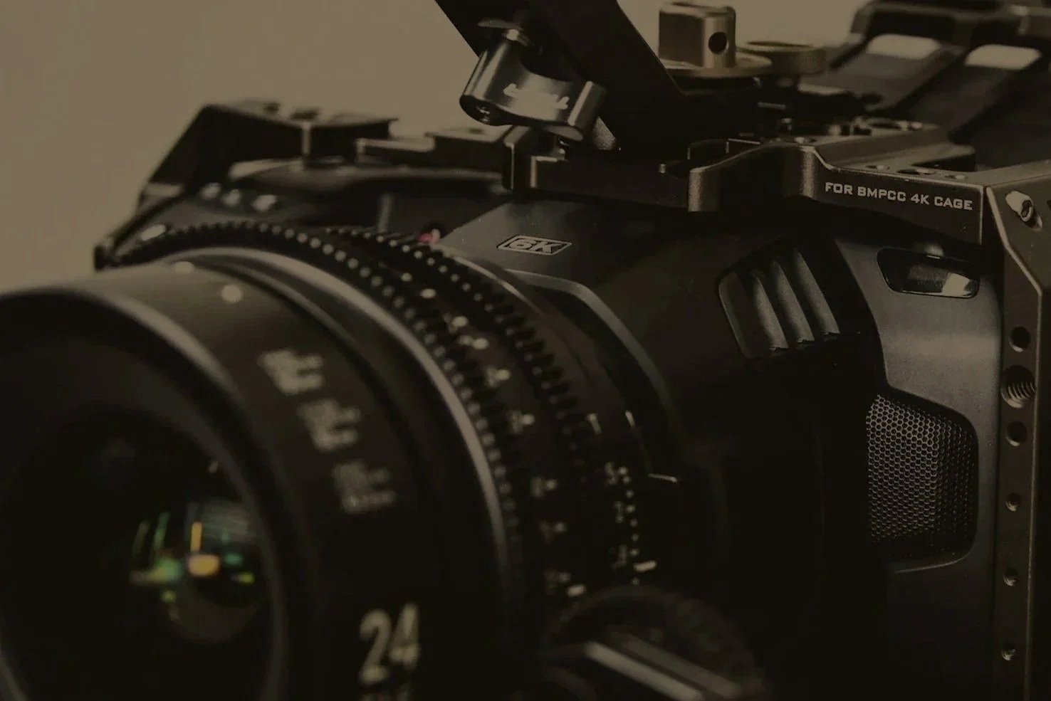 Close-up of a professional camera with detailed controls and lens, mounted on a stabilization rig.