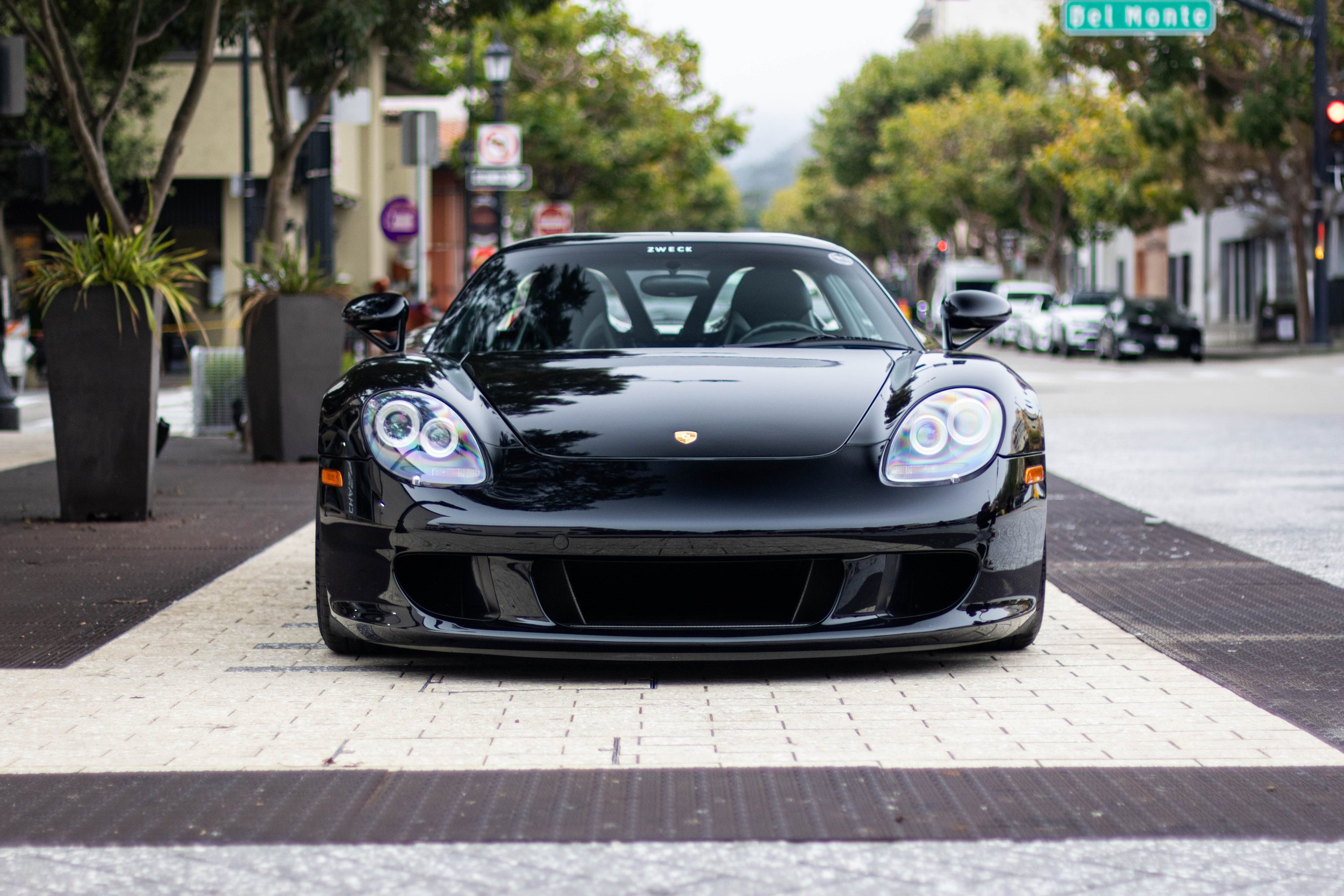 Black Porsche Carrera GT parked in the streets of Monterey during Monterey Car Week
