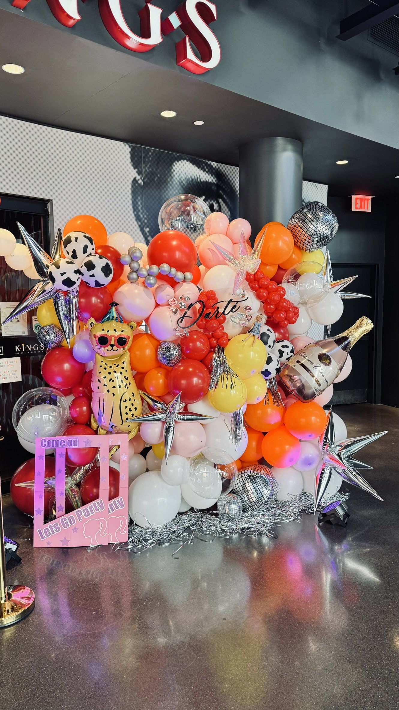 Colorful balloon wall with disco ball balloons, star details, and custom party styling for a celebration in Boston.