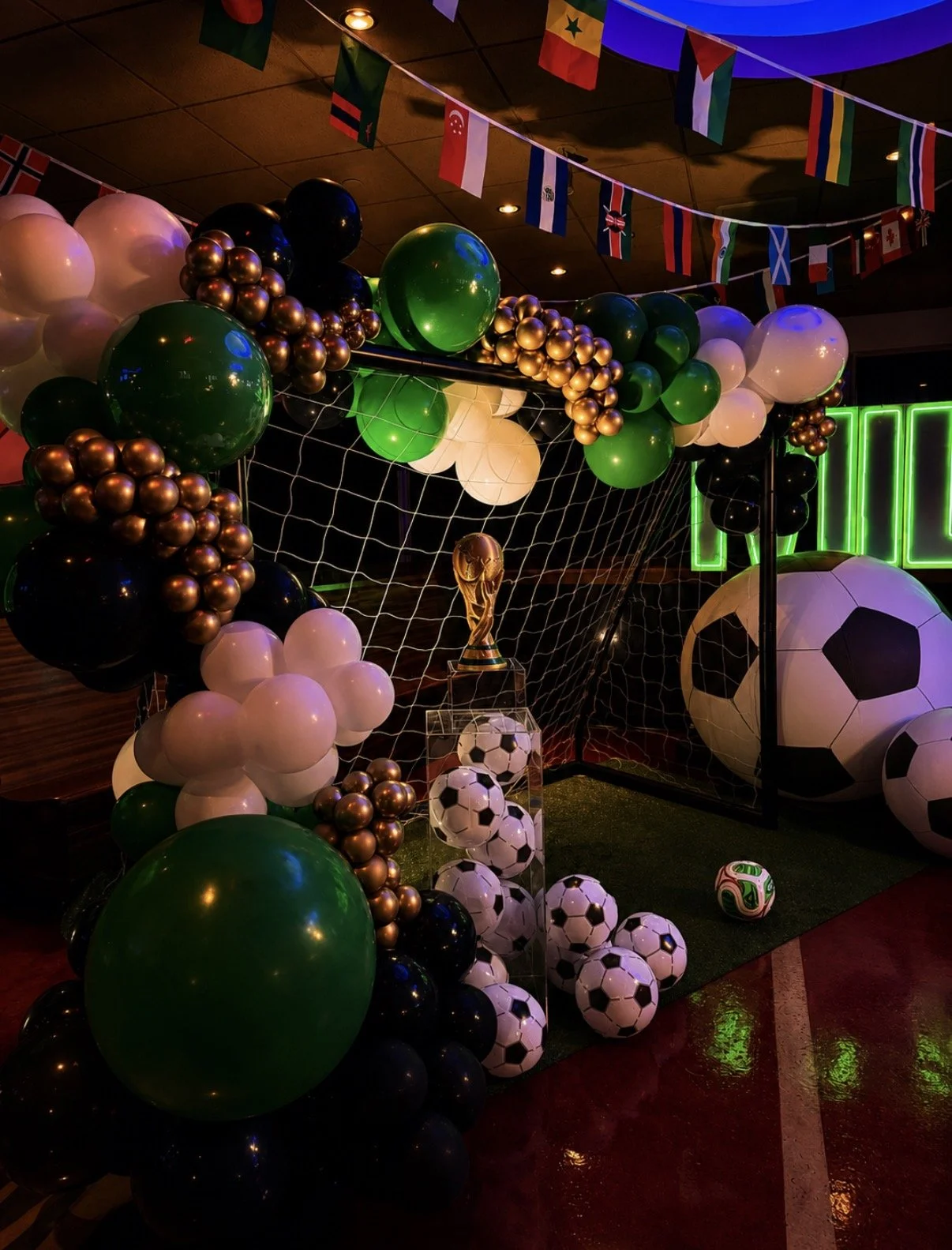 World Cup FIFA-inspired Bar Mitzvah balloon decor with soccer details, trophy display, and international flags in Boston.