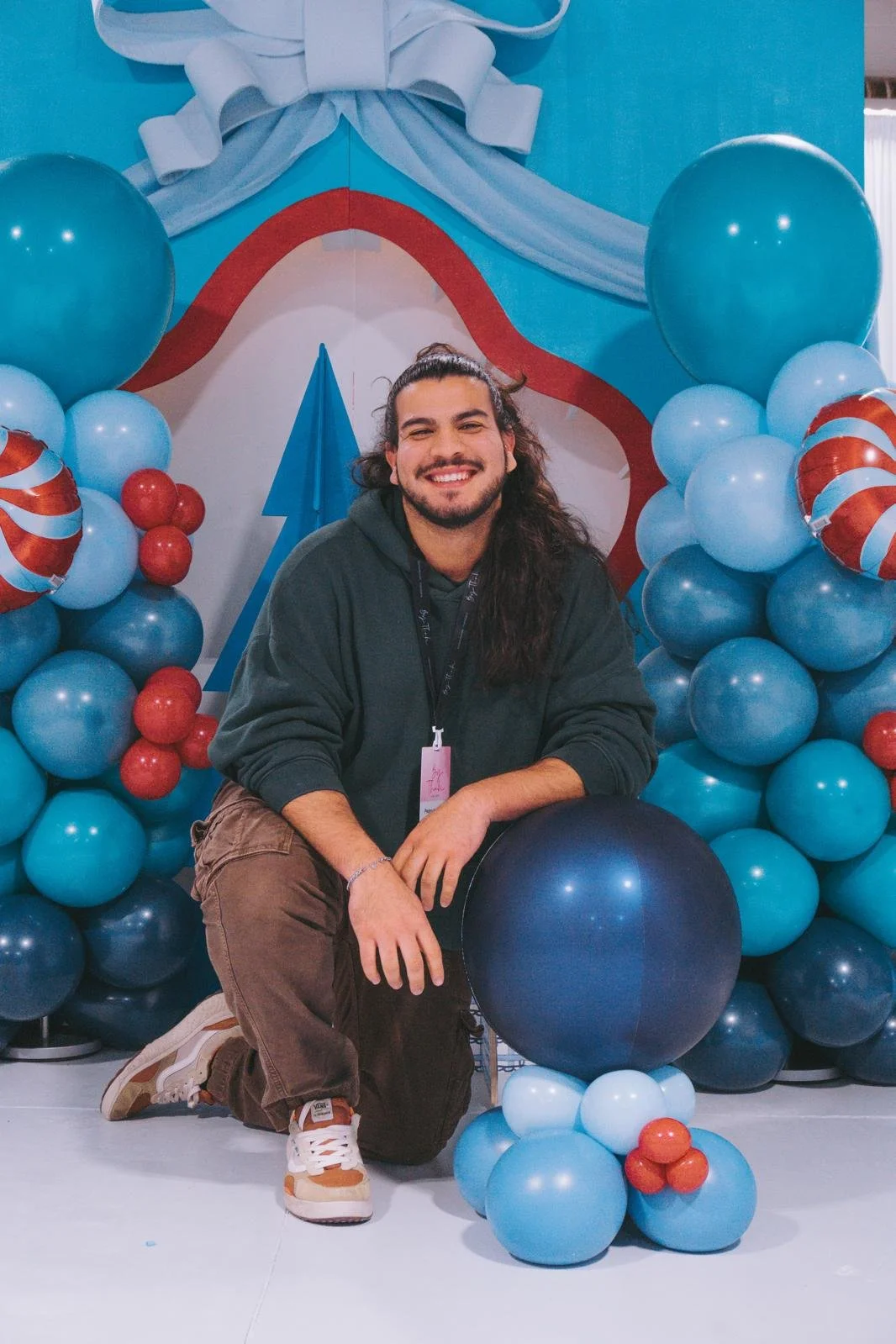 Custom birthday party balloon backdrop with blue and red balloons and themed decor in Boston.