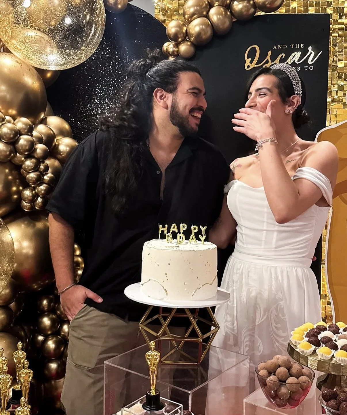 Elegant birthday celebration decor with gold balloons, cake table, and styled party backdrop in Boston.