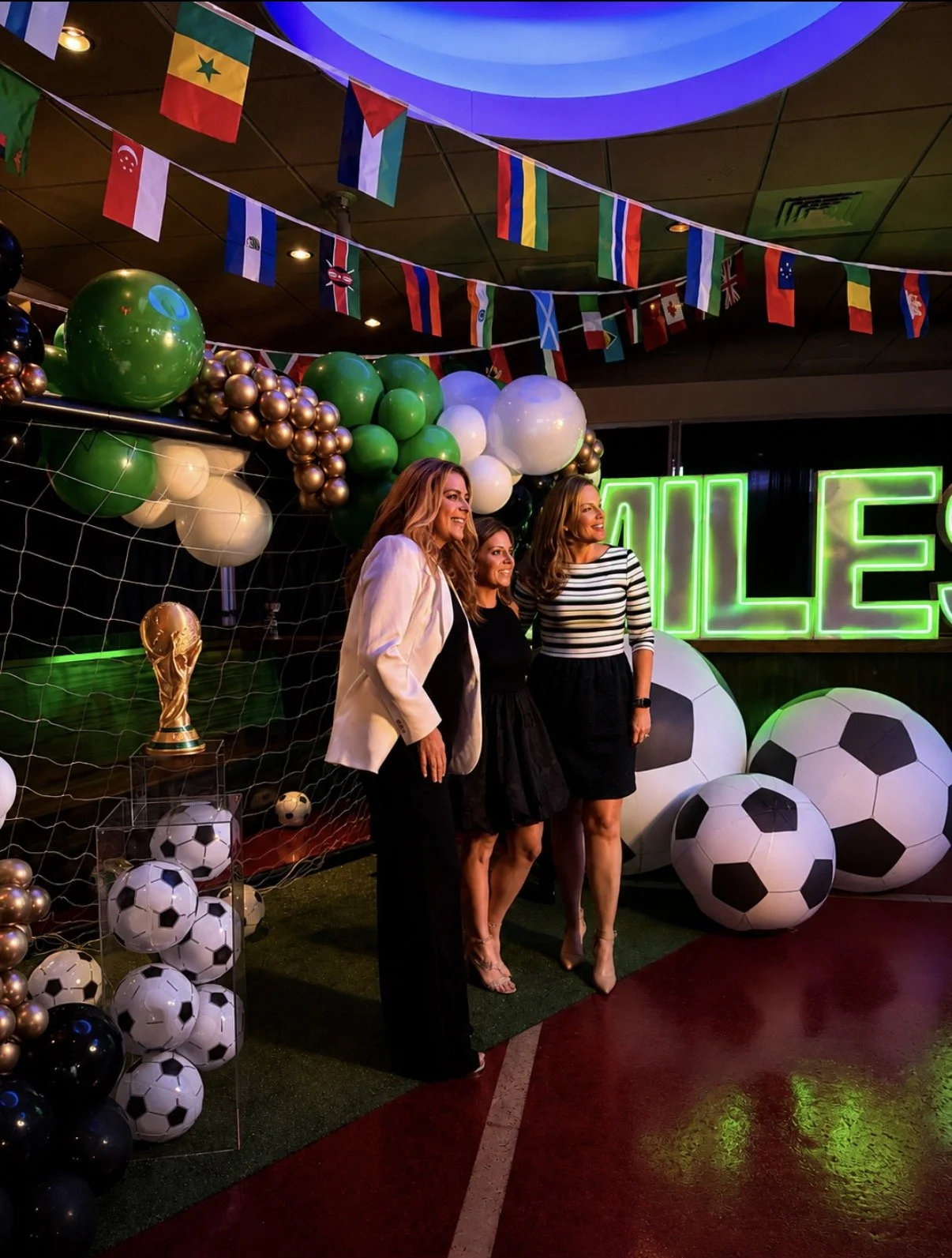 World Cup-inspired Bar Mitzvah photo booth setup with soccer-themed balloons, international flags, and custom sports decor in Boston.