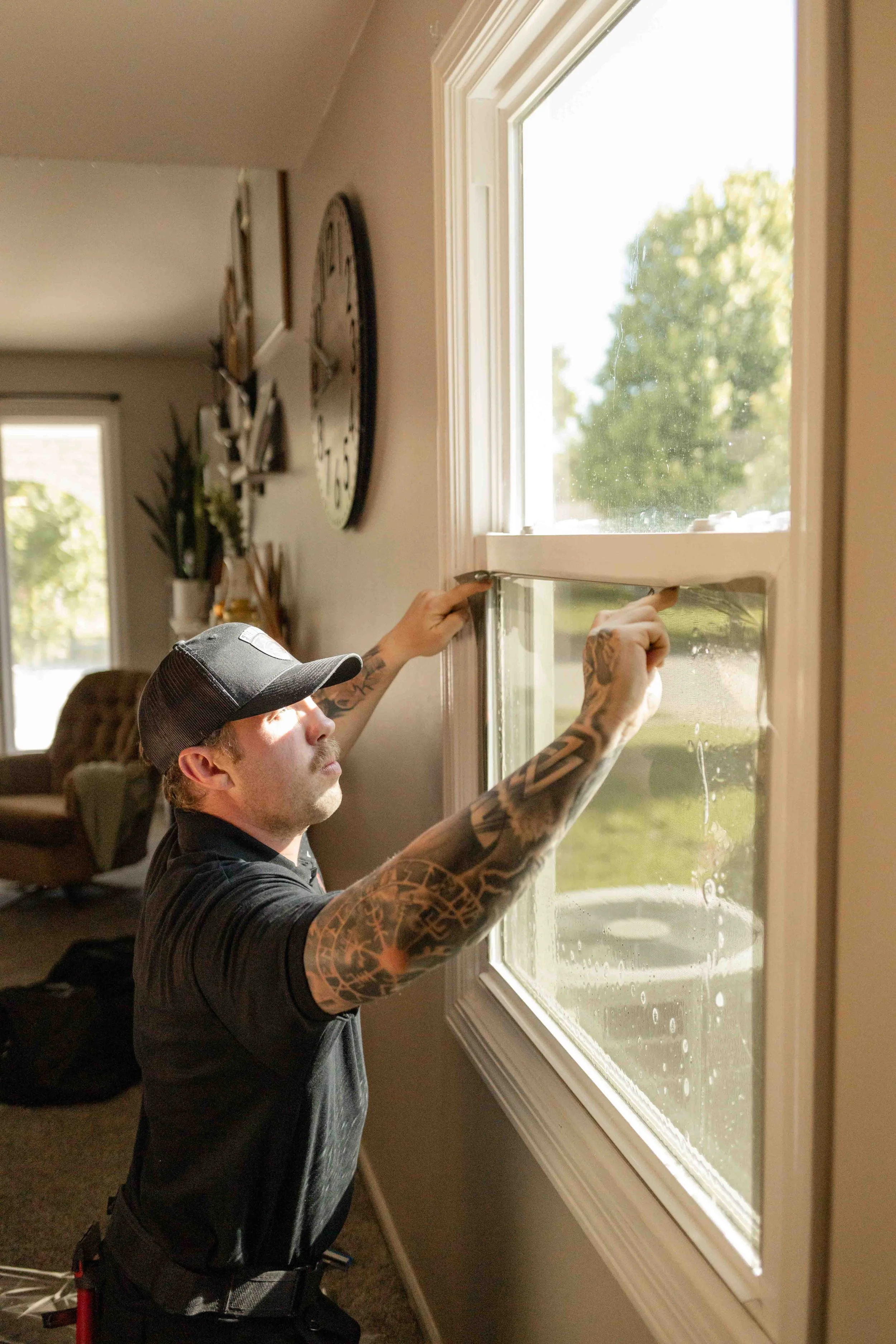 Frontline Tint LLC owner tinting a window