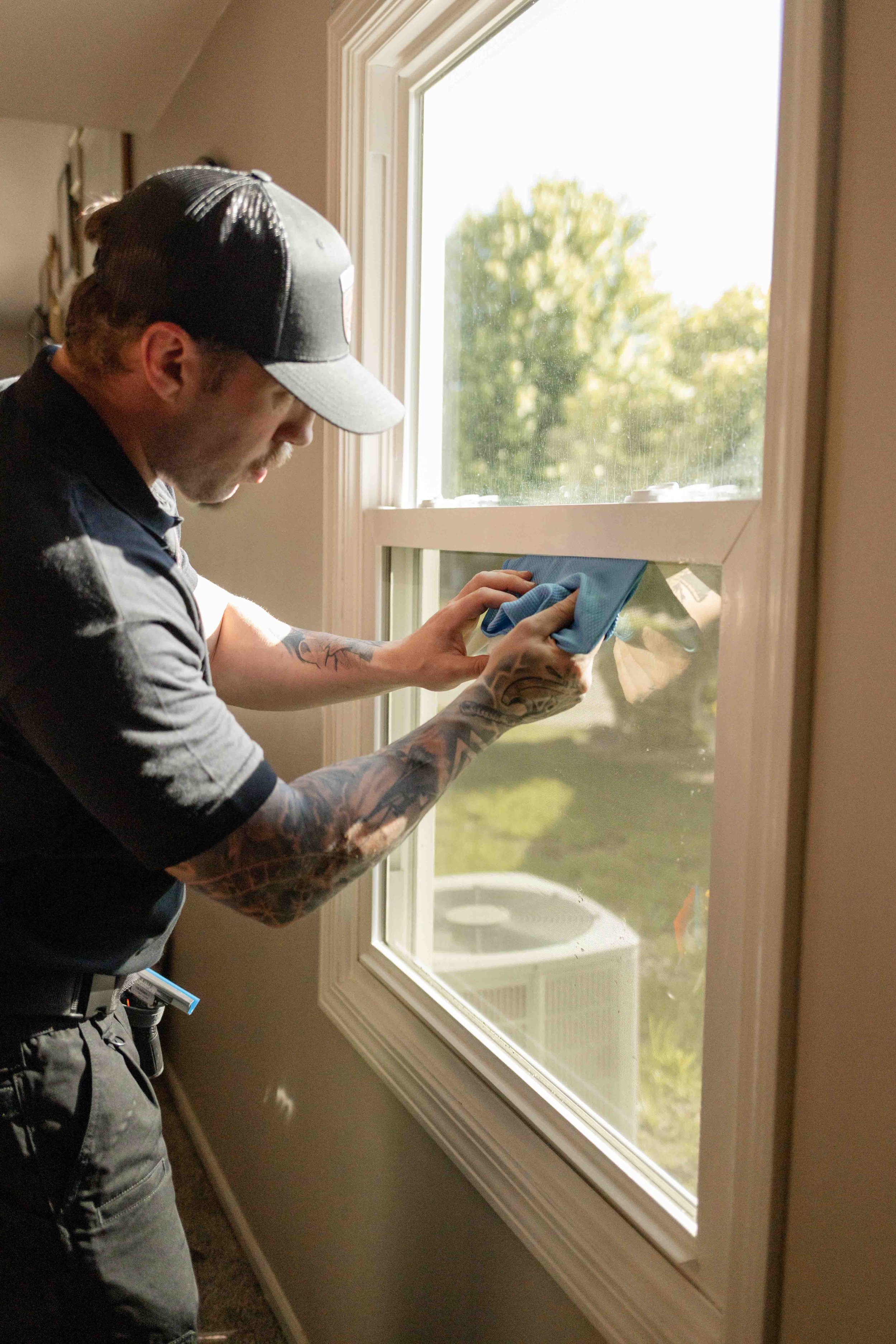 Frontline Tint LLC owner tinting a window