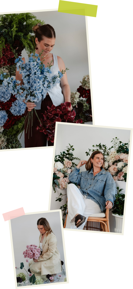 Three women surrounded by flowers in a floral setting, one holding a bouquet of blue flowers, another sitting among pink and white roses, and the third holding a large bouquet of pink flowers.
