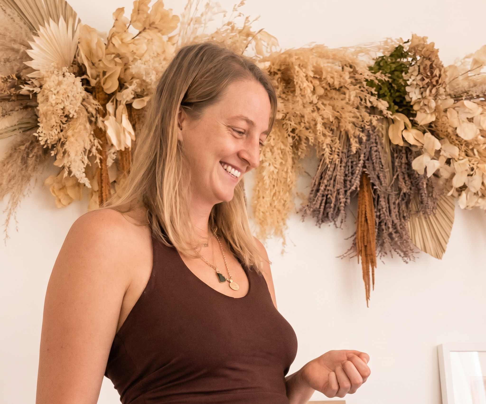 Spinal energetics, breathwork, reiki healing practitioner Elleanor smiling during a wellness healing session, Airlie Beach Queensland