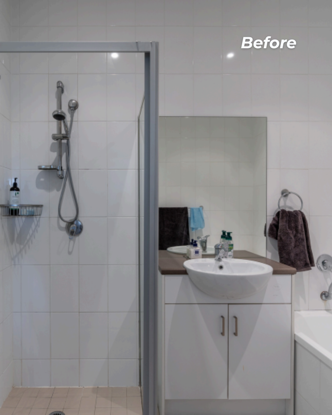 Bathroom with shower area, mirror, sink, and bathtub, towels on towel rings, toiletries on shelves and counters.
