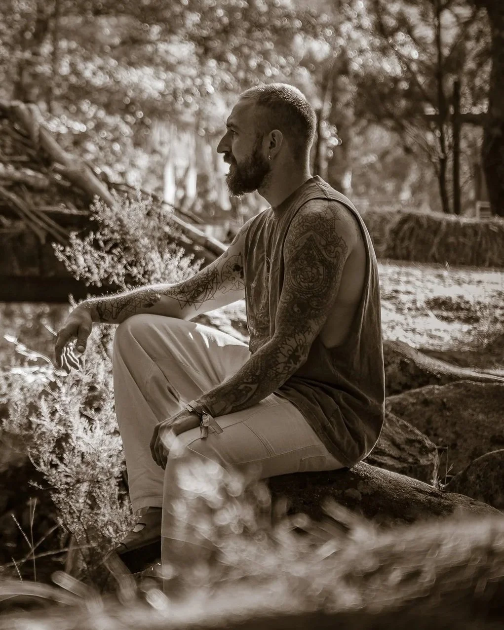 Kane Rogerson sitting outdoors in a wooded setting