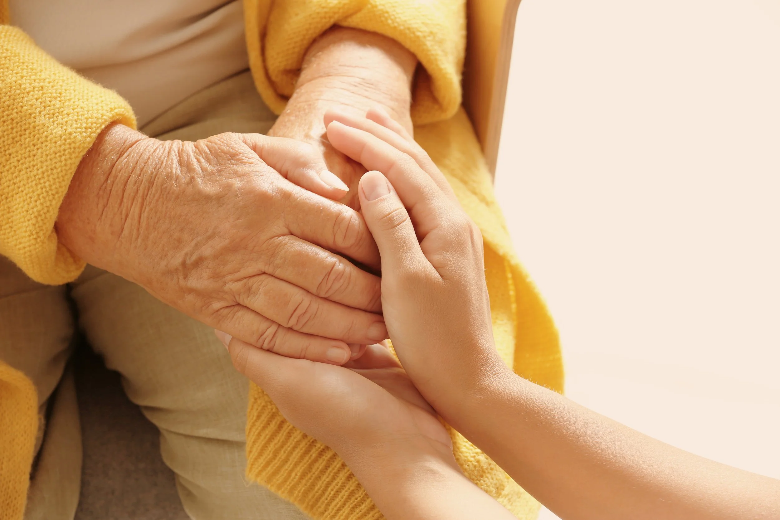 helping-hands-on-light-background-closeup-elderl-2026-03-05-11-40-58-utc.jpg