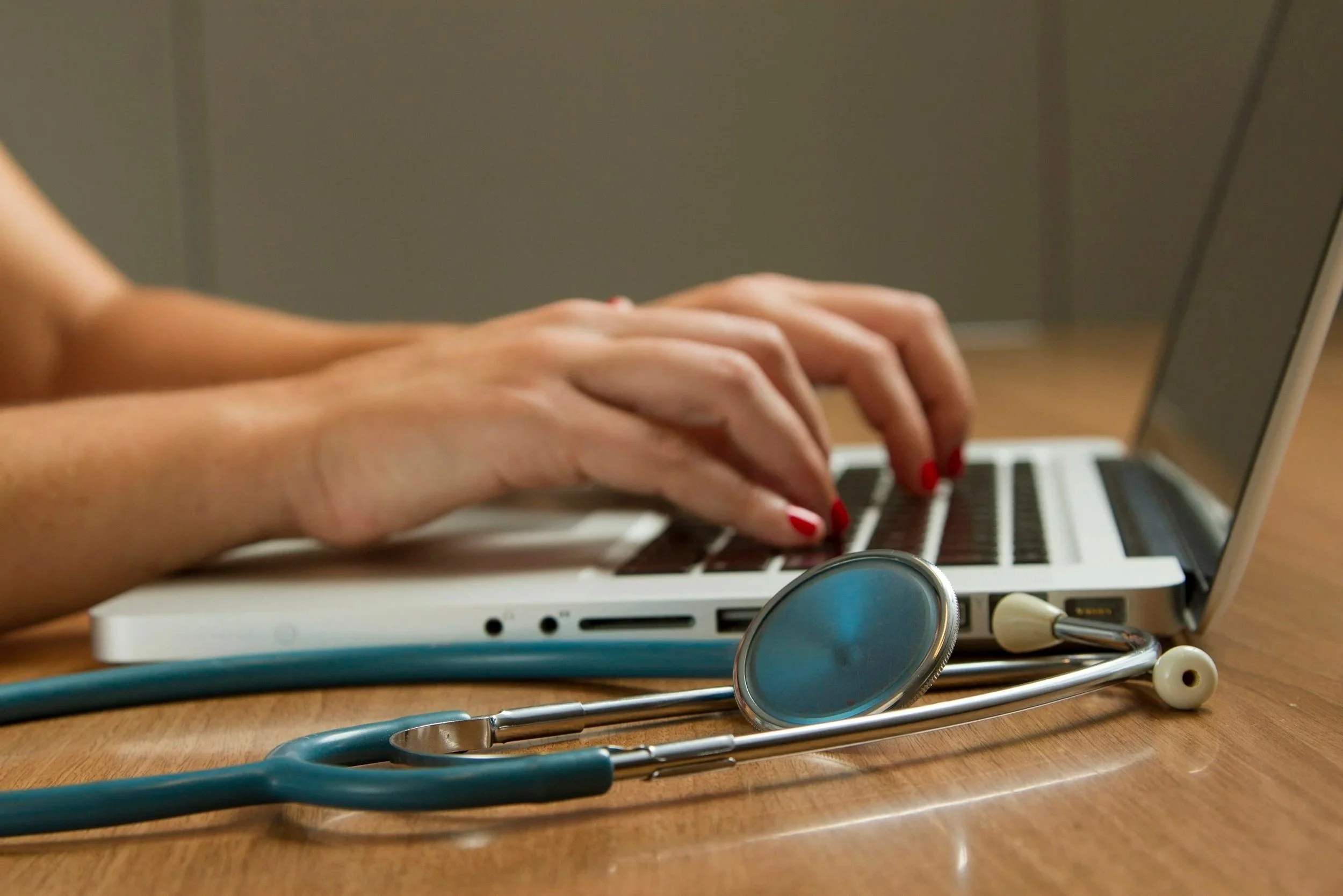 Doctor typing on computer