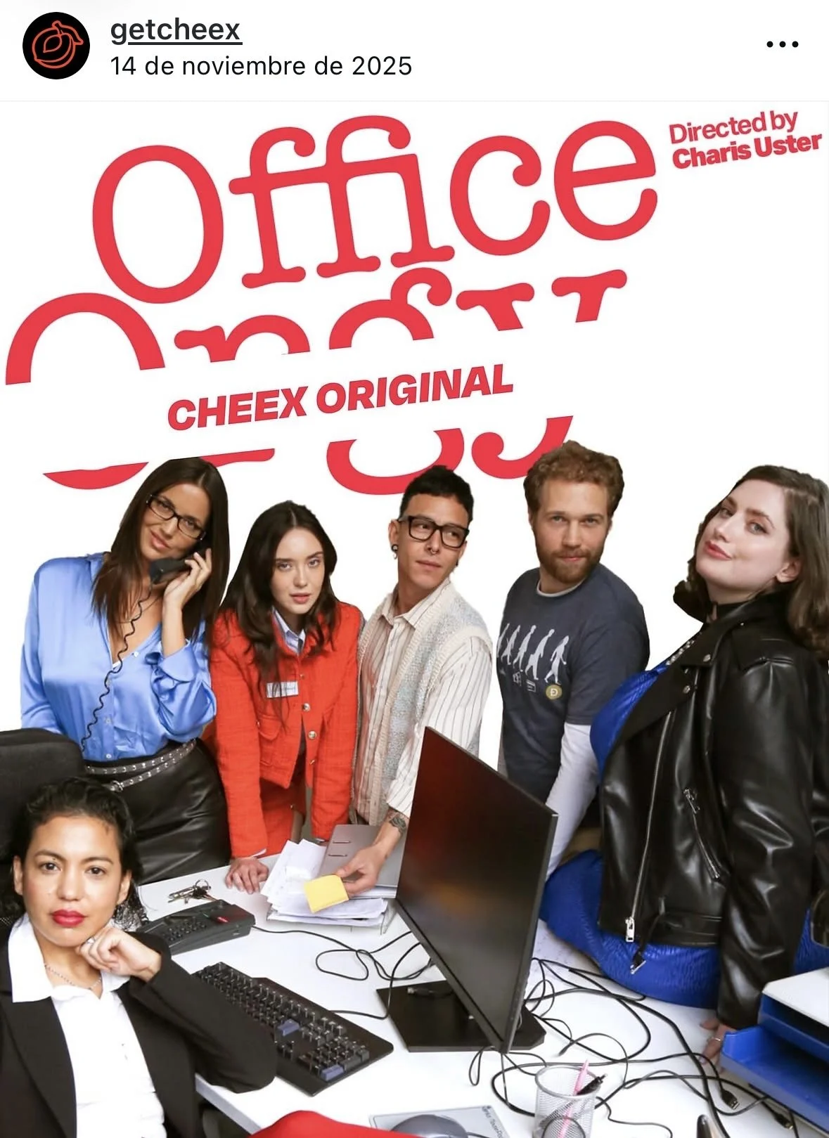 Cast of the show 'Office' with five people standing around a desk, with computer monitors and office supplies, against a white background featuring the show's logo and credits.