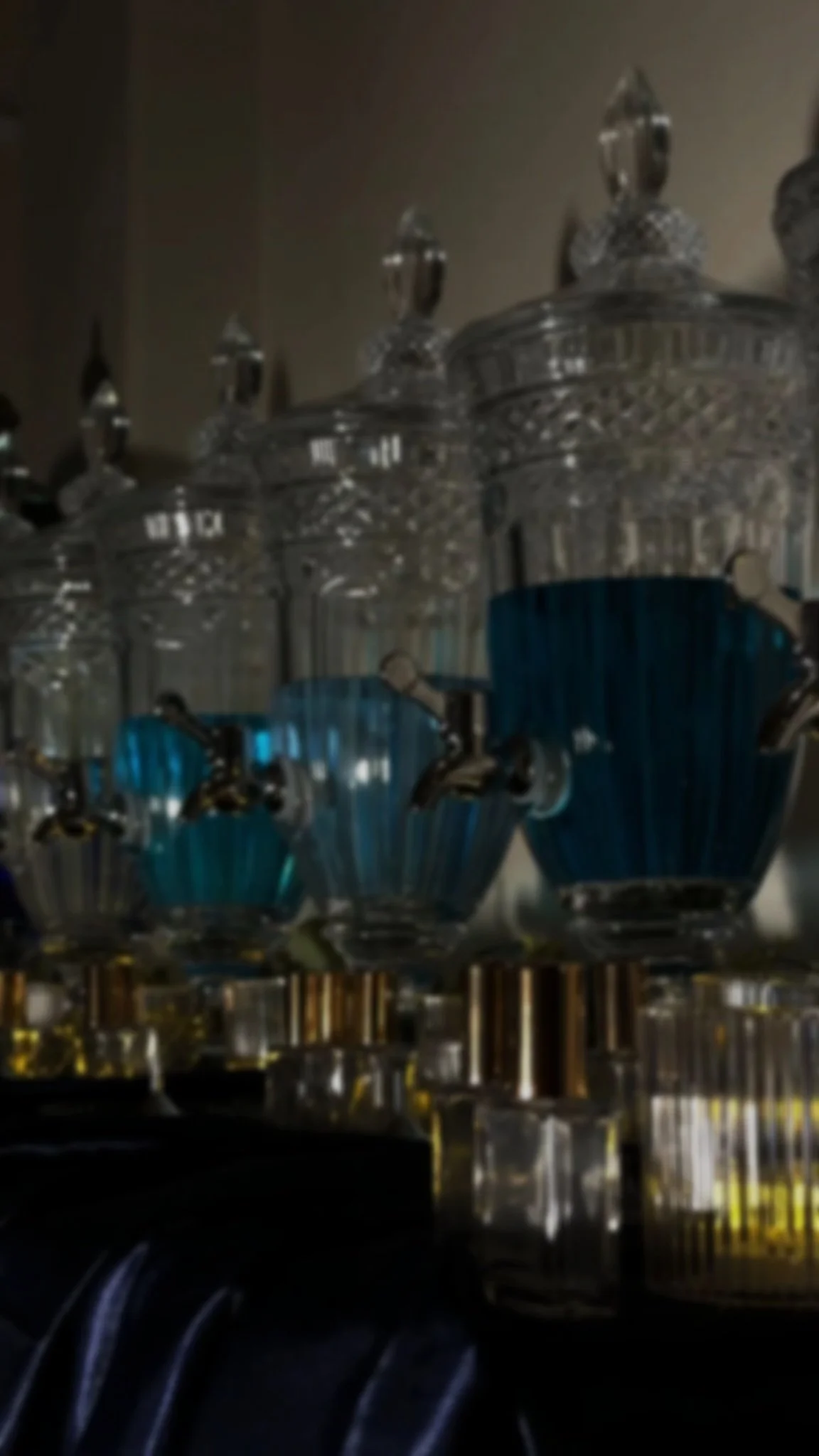 Close-up of a chandelier with multiple glass crystals and blue glass accents.