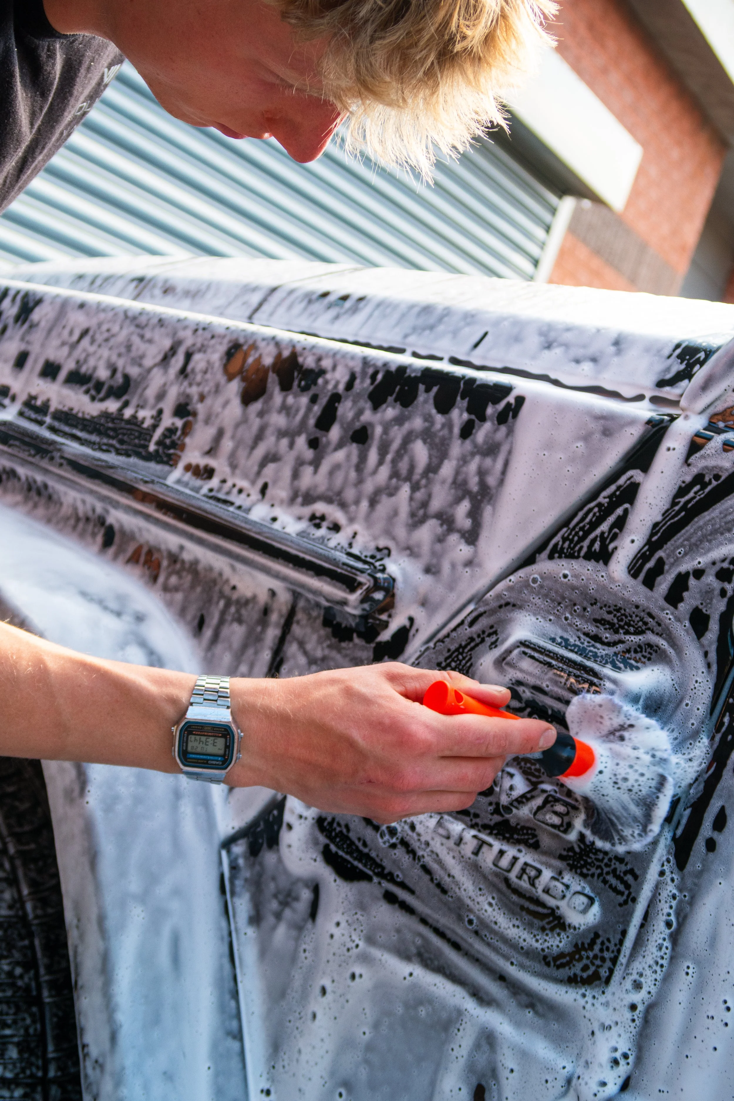 Professional car valeting service cleaning a black car in Bristol by Evolution Valets using safe wash and detailing techniques