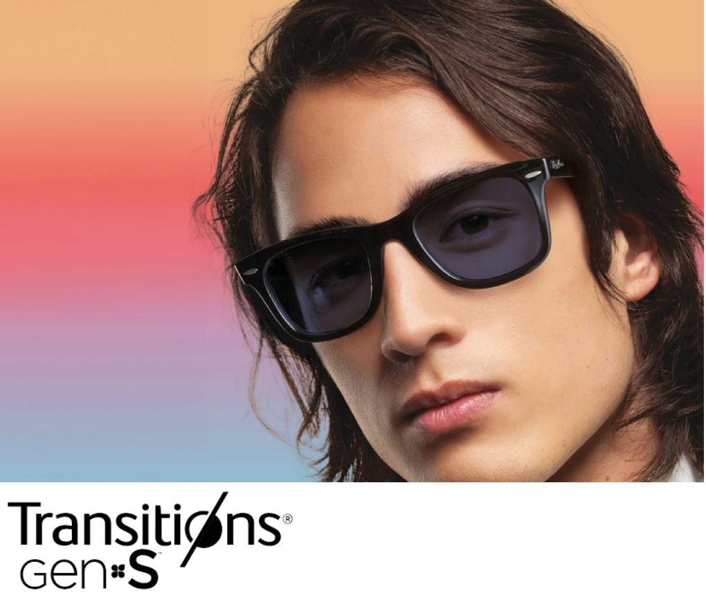 Young man with shoulder-length dark hair wearing black sunglasses against a colorful gradient background.
