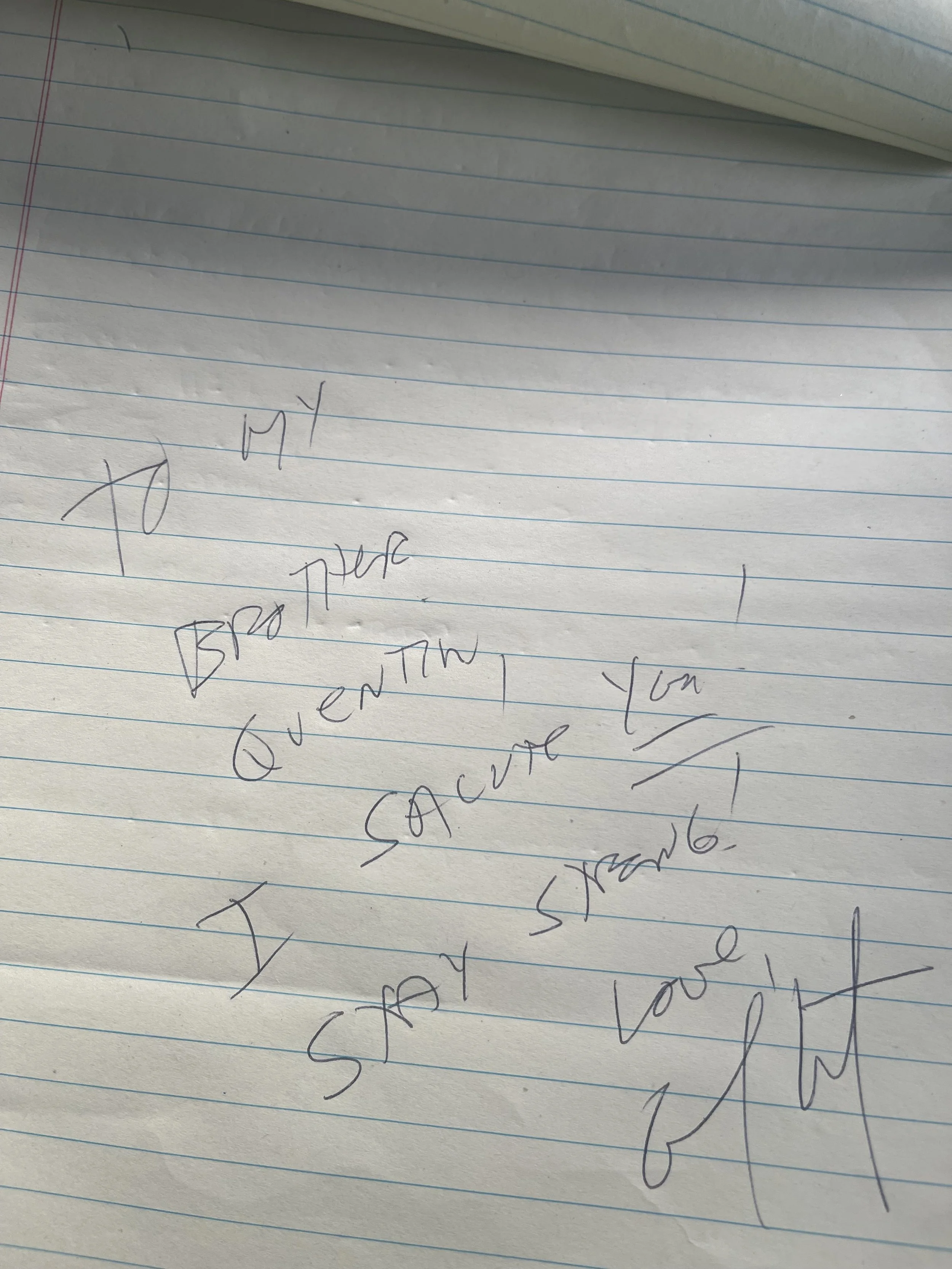 A close-up photo of a piece of lined paper with handwritten words in cursive. The visible part of the writing includes the words 'FYI,' 'BY,' 'APPLICATION,' and some other partially obscured and illegible words.