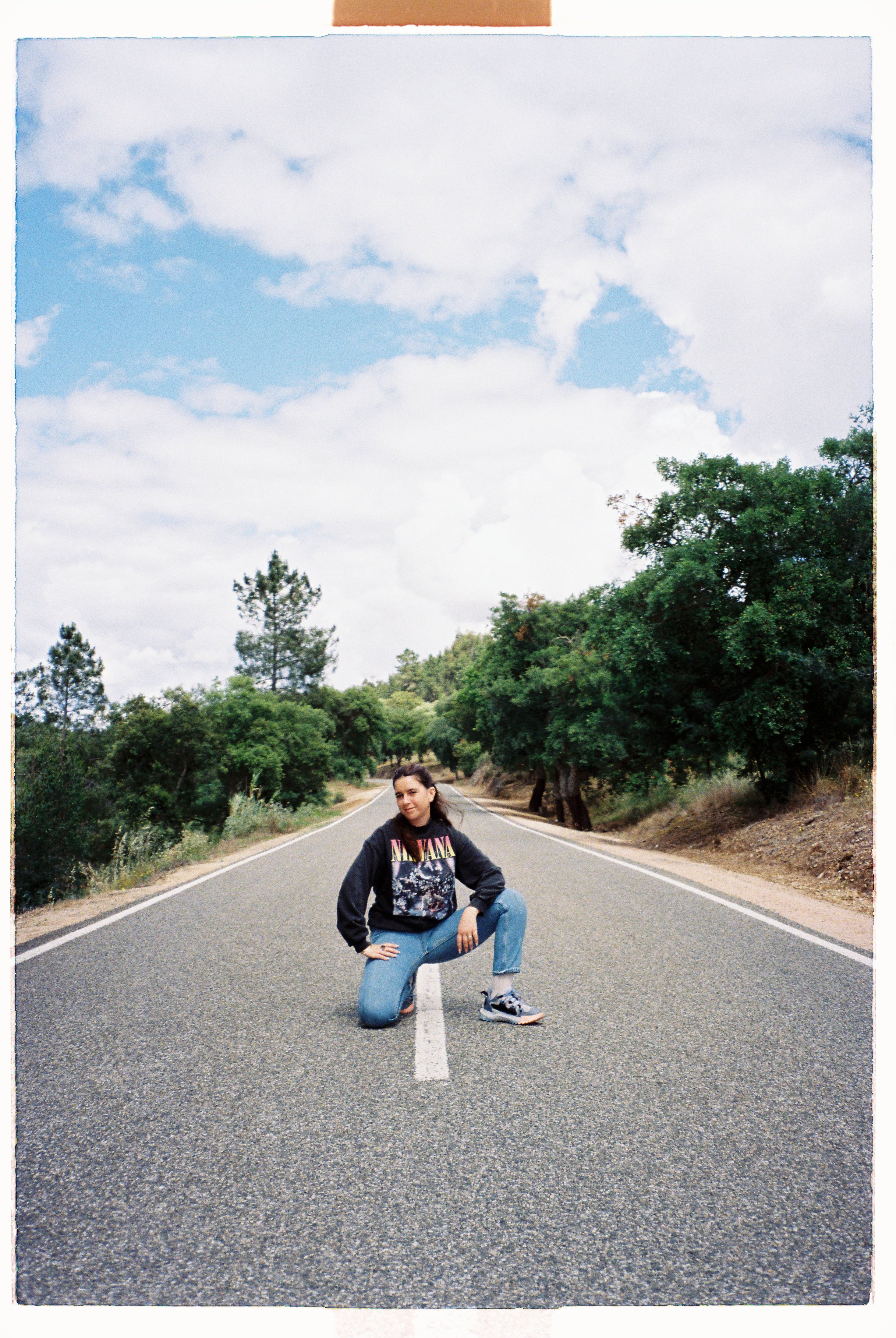 A girl standing in the middle of the road in Alentejo