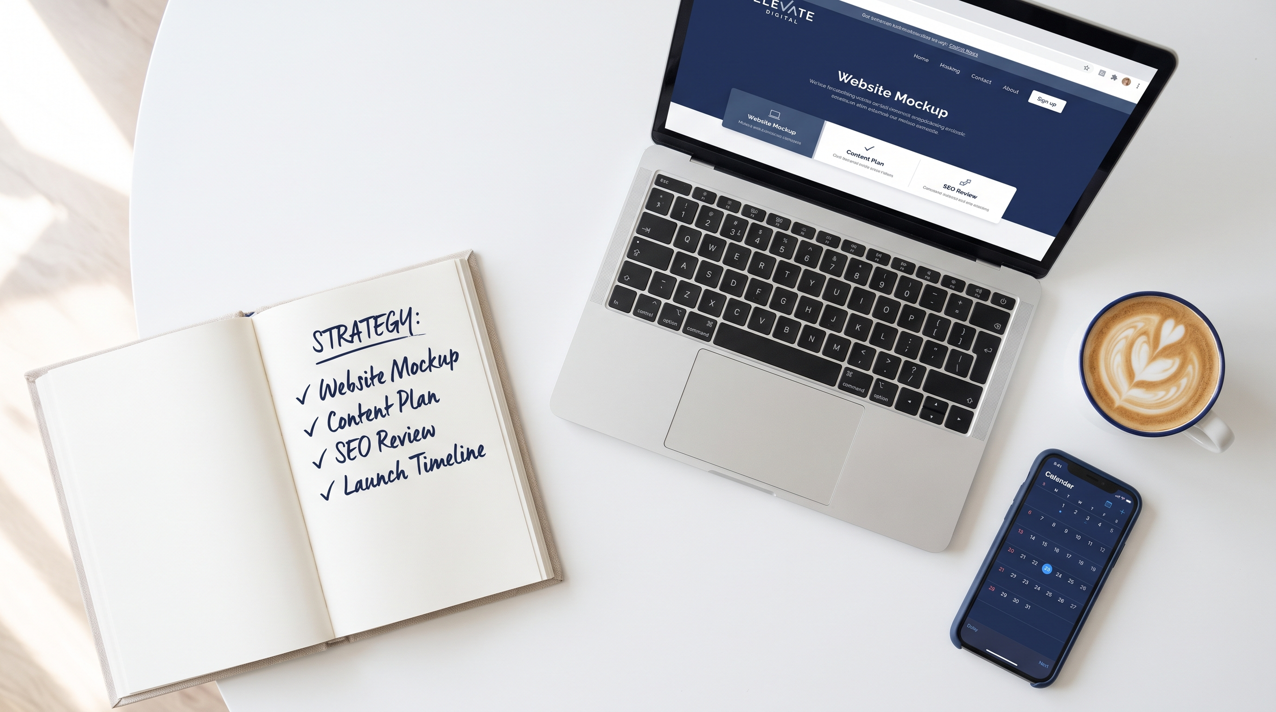 Notebook checklist of questions to ask before hiring a web designer, next to a laptop and coffee